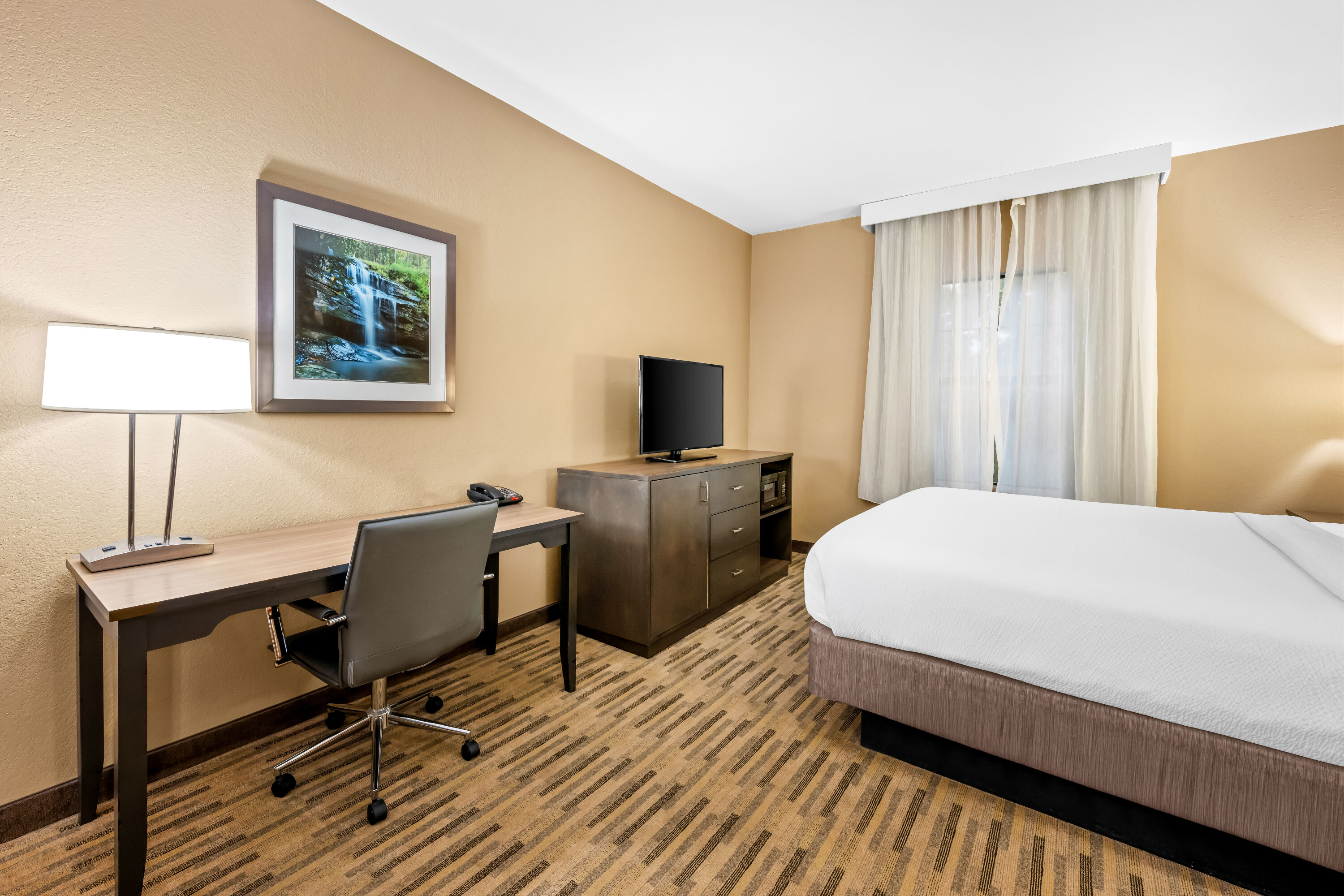 King bed guest room at the La Quinta Inn & Suites by Wyndham Boone University in Boone, North Carolina