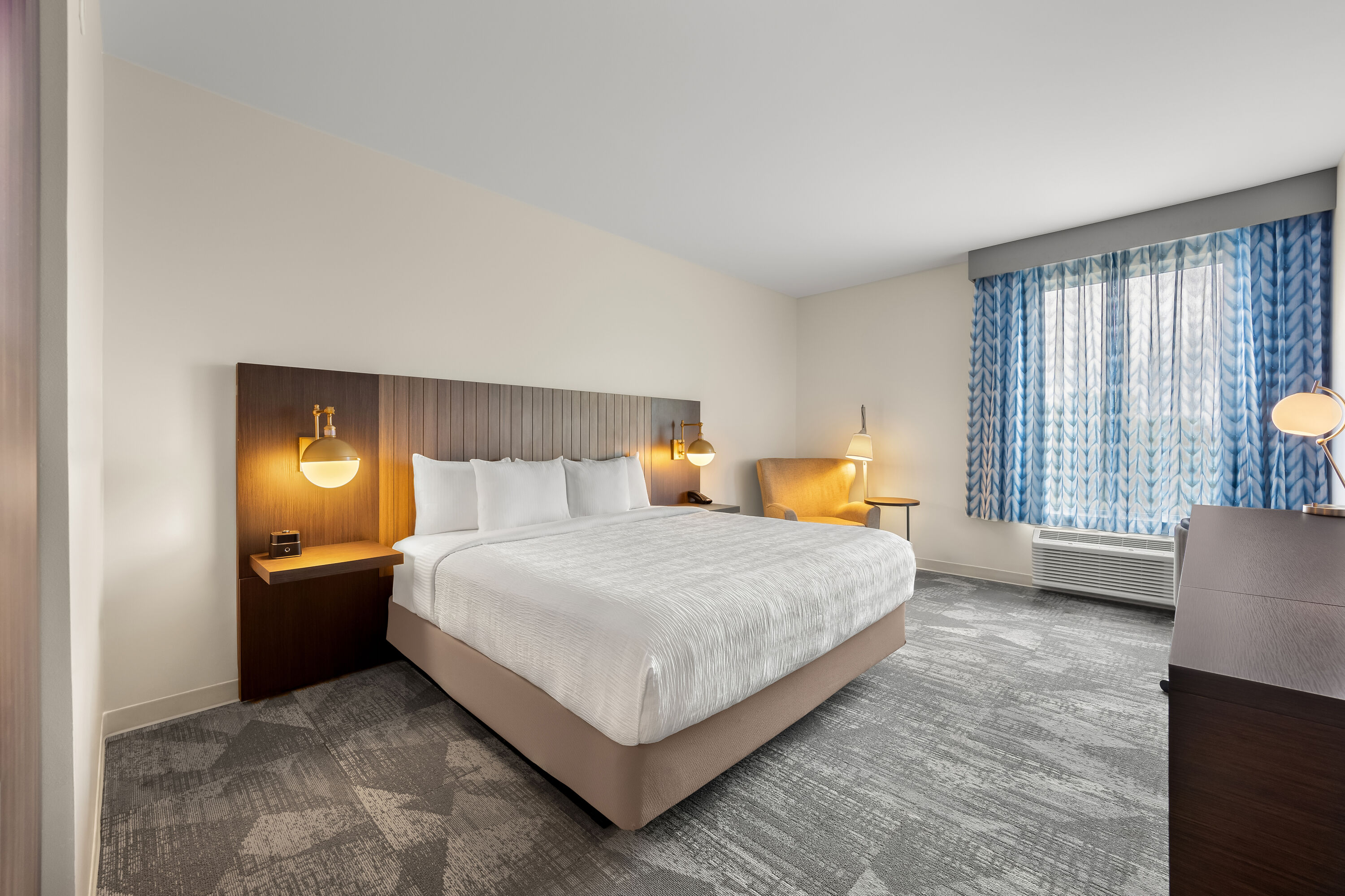King bed guest room at the La Quinta Inn & Suites by Wyndham Mebane in Mebane, North Carolina
