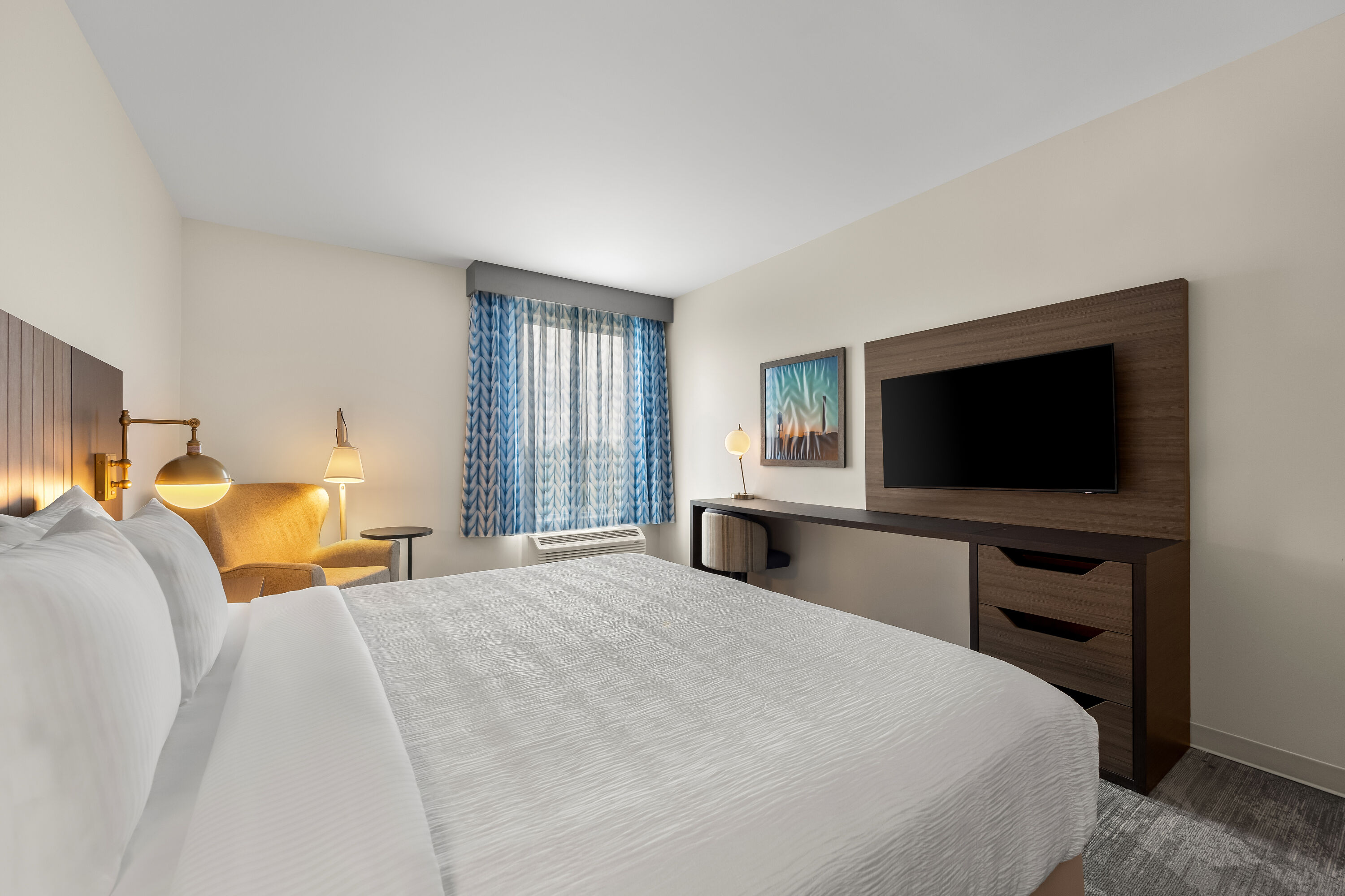 King bed guest room at the La Quinta Inn & Suites by Wyndham Mebane in Mebane, North Carolina