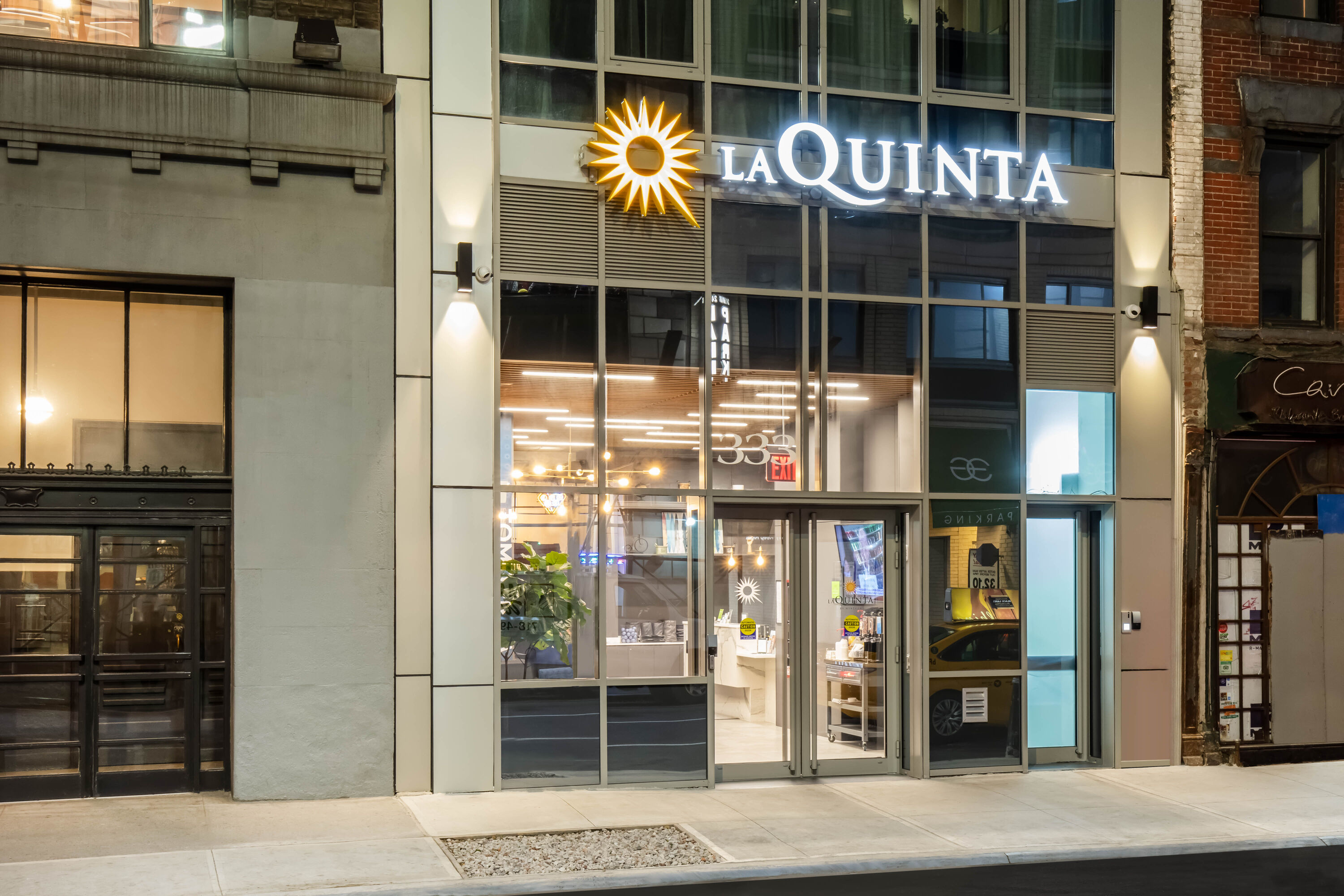 Exterior Dusk Image of La Quinta Inn & Suites by Wyndham Times Square South hotel in New York City, New York