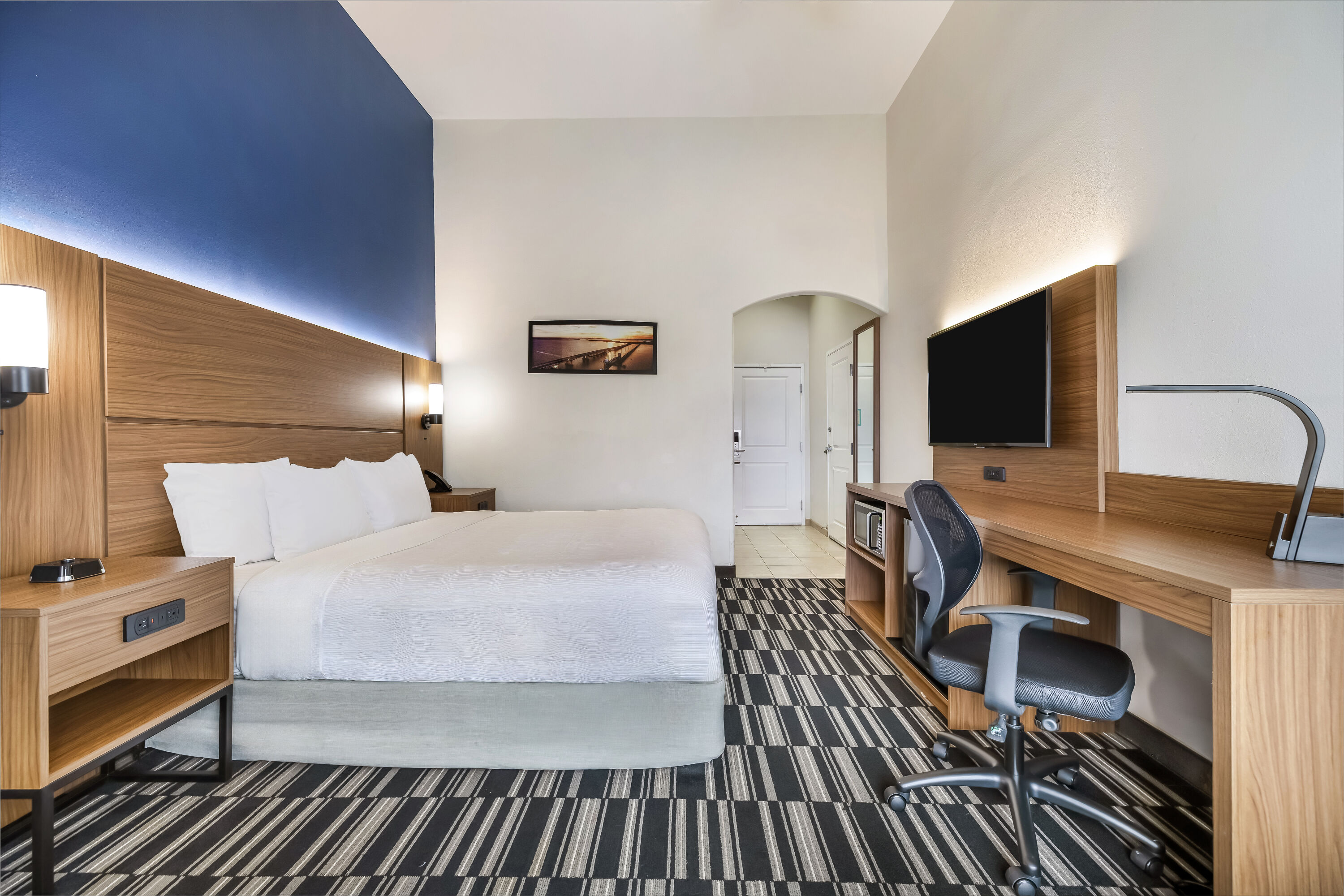 King bed guest room at the La Quinta Inn & Suites by Wyndham Alvin in Alvin, Texas