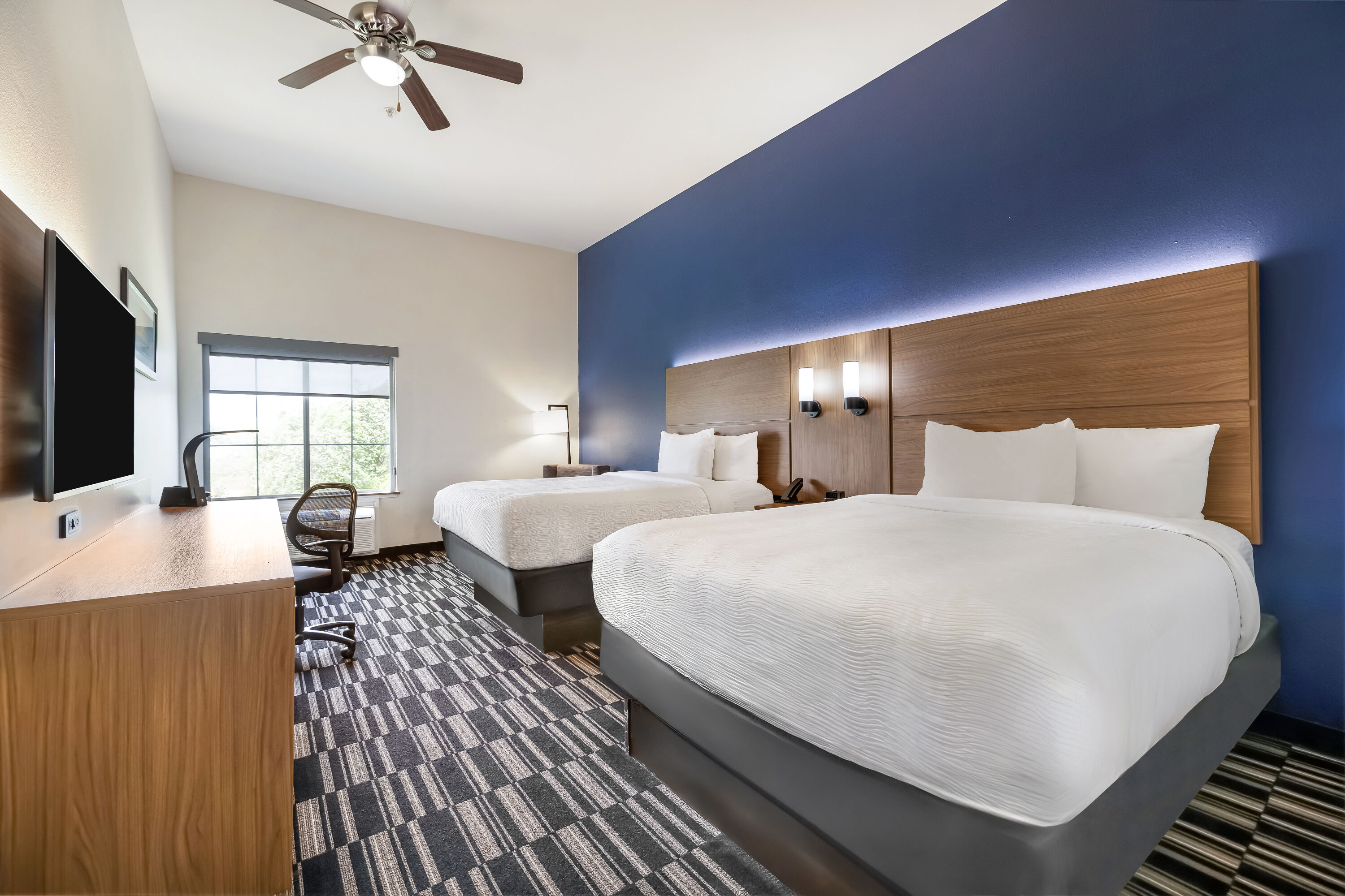 Queen bed guest room at the La Quinta Inn & Suites by Wyndham Alvin in Alvin, Texas