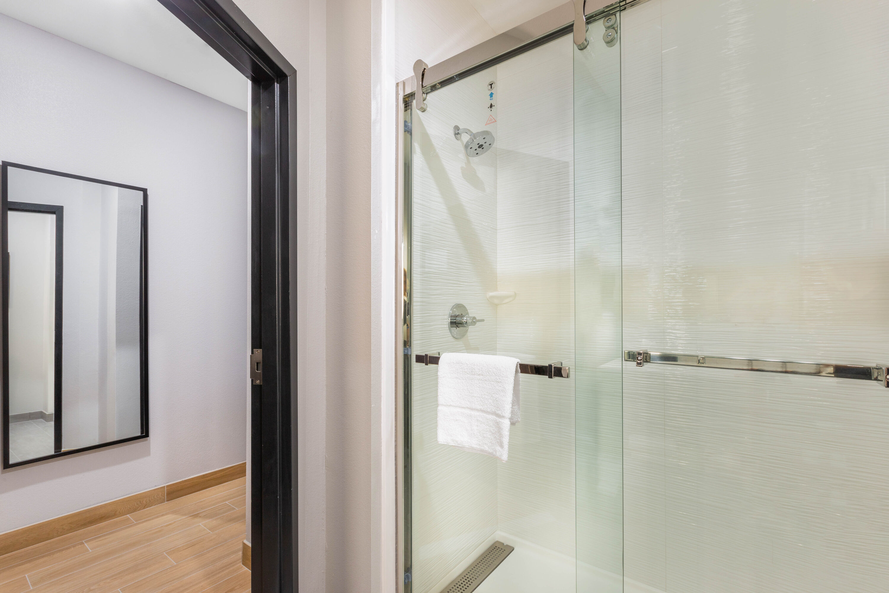 Guest room bath at the La Quinta Inn & Suites by Wyndham Galveston West Seawall in Galveston, Texas