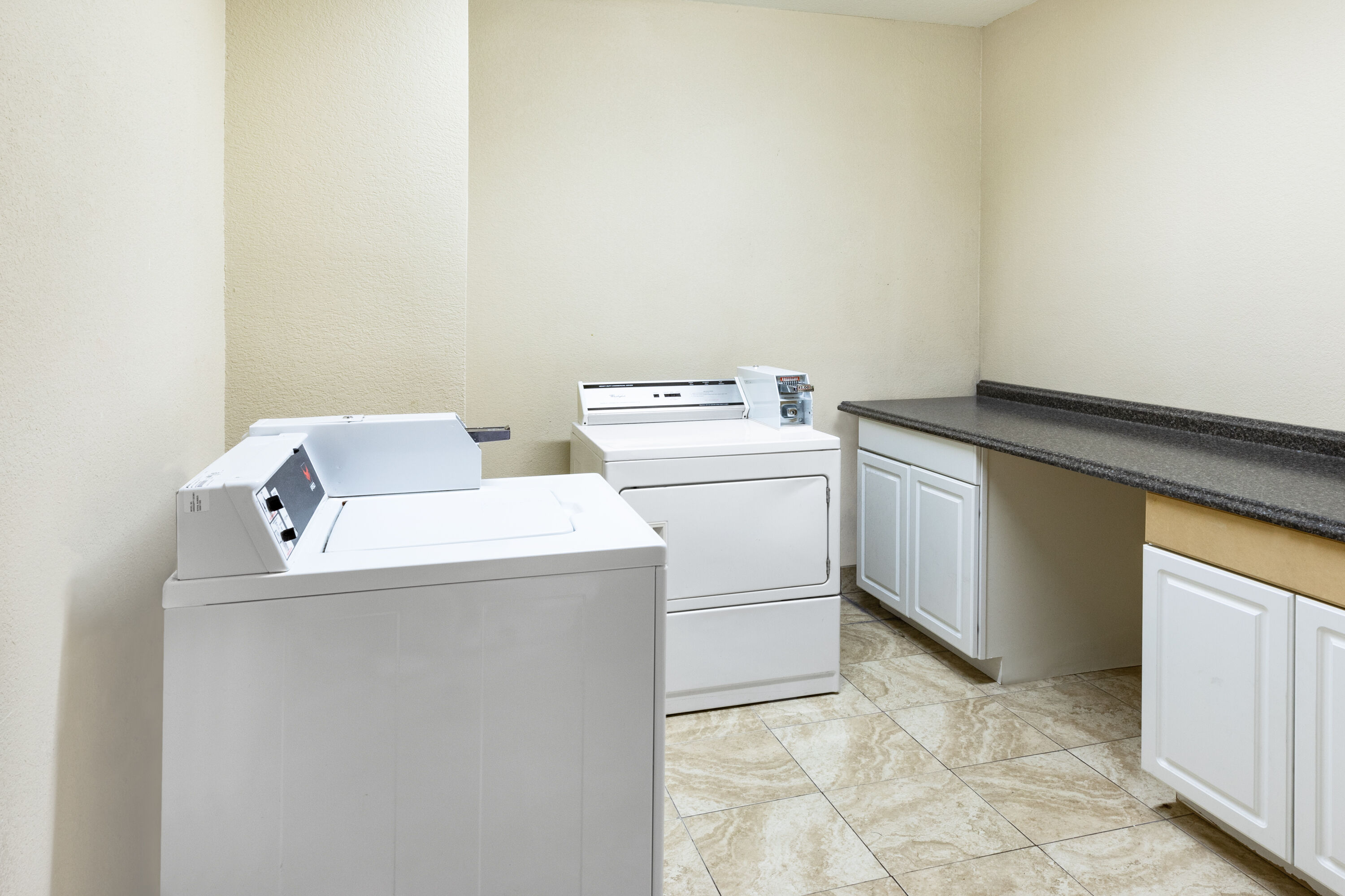 Laundry facilities at La Quinta Inn & Suites by Wyndham Garland Harbor Point in Garland, Texas
