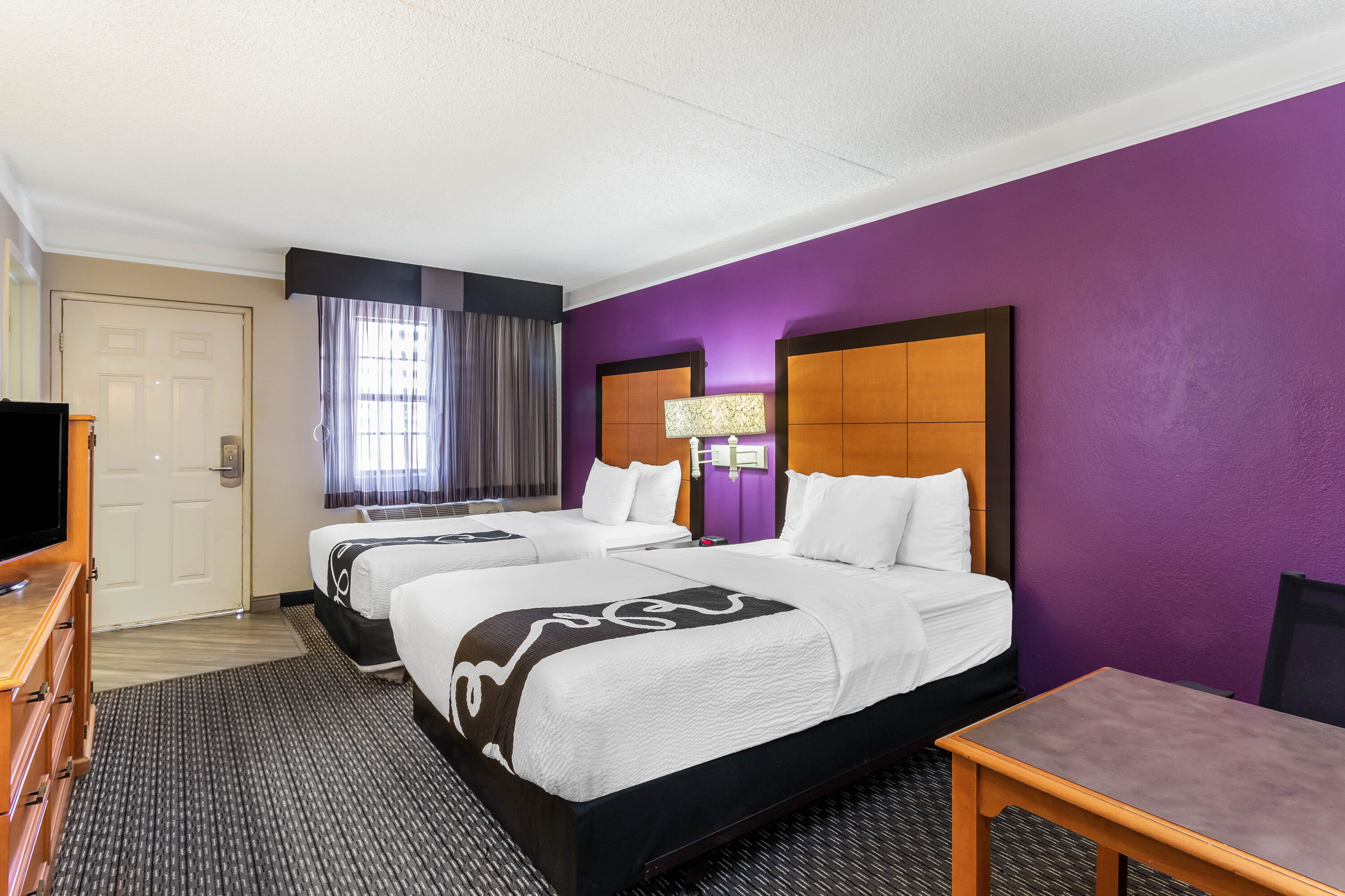 Guest room at the La Quinta Inn by Wyndham Odessa in Odessa, Texas