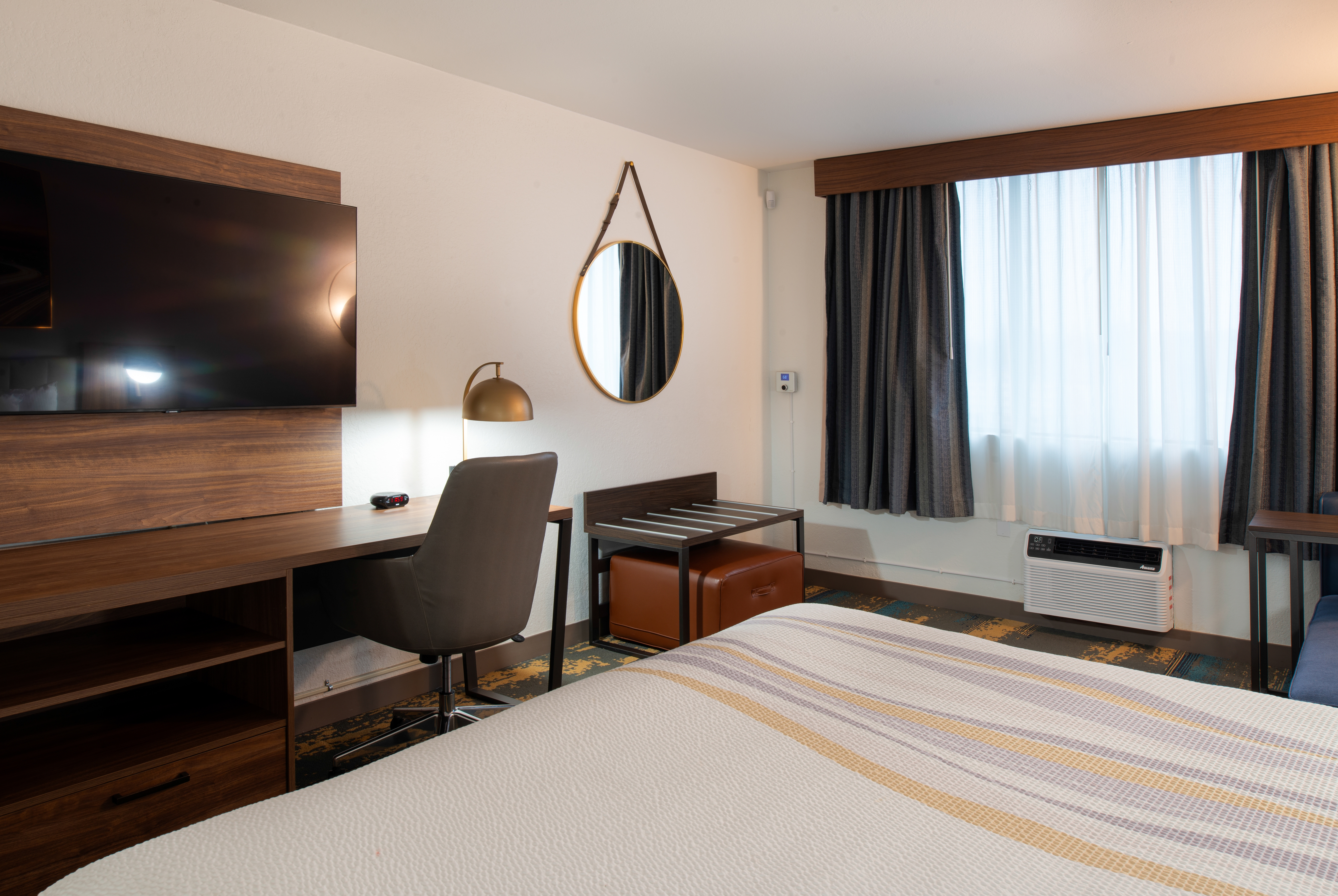 King bed guest room at the La Quinta Inn & Suites by Wyndham Seattle Sea-Tac Airport in Seattle, Washington