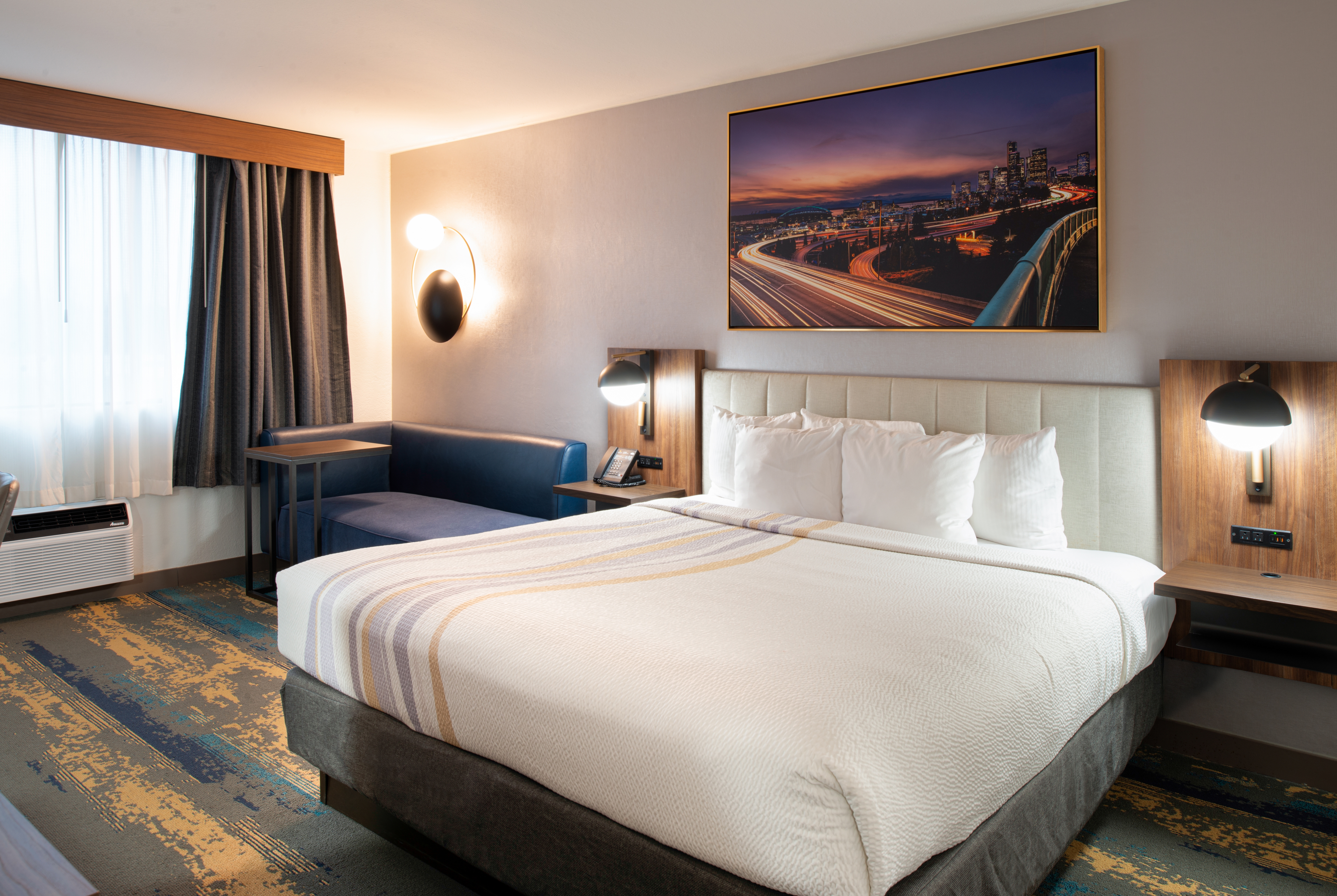 King bed guest room at the La Quinta Inn & Suites by Wyndham Seattle Sea-Tac Airport in Seattle, Washington