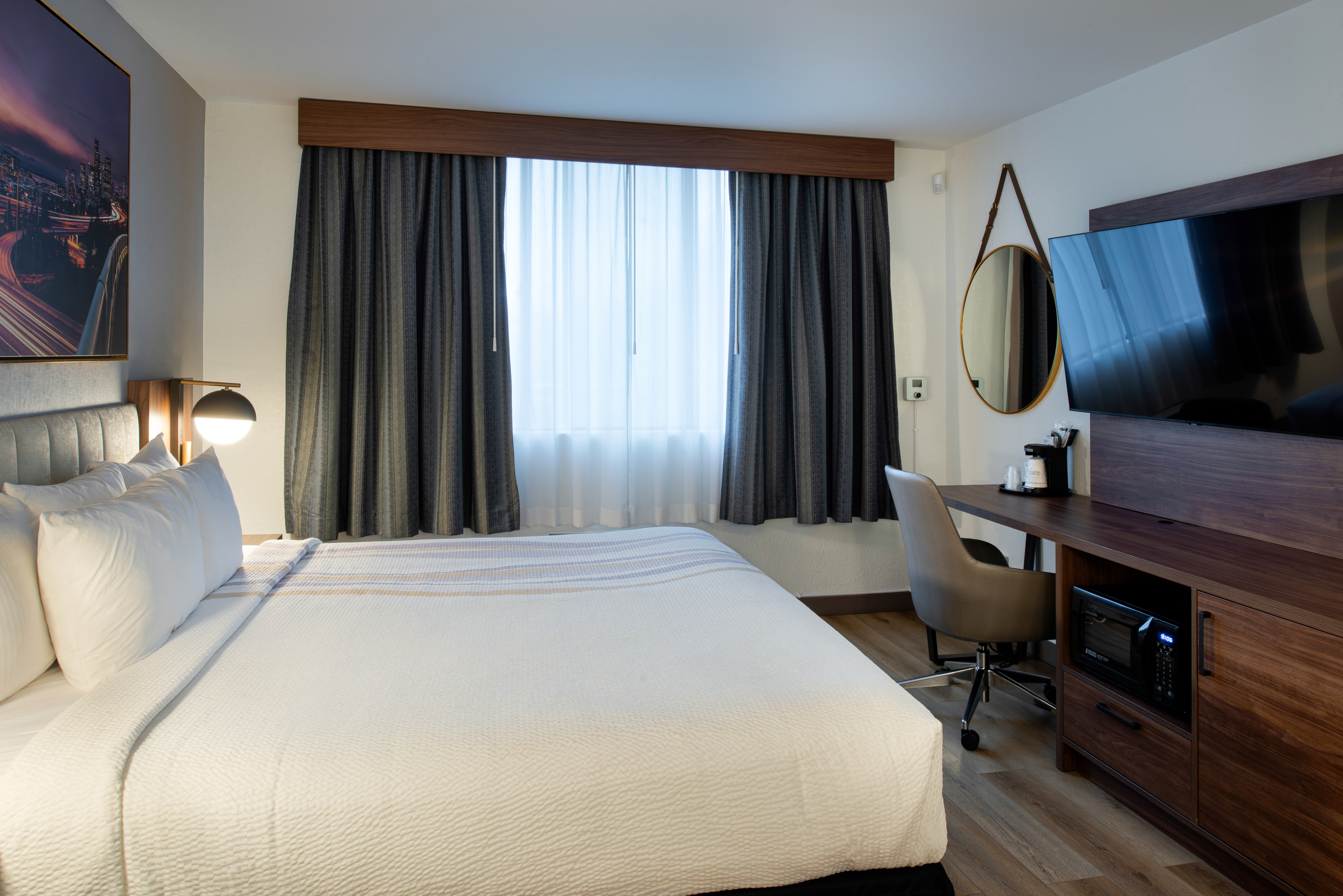 King bed guest room at the La Quinta Inn & Suites by Wyndham Seattle Sea-Tac Airport in Seattle, Washington