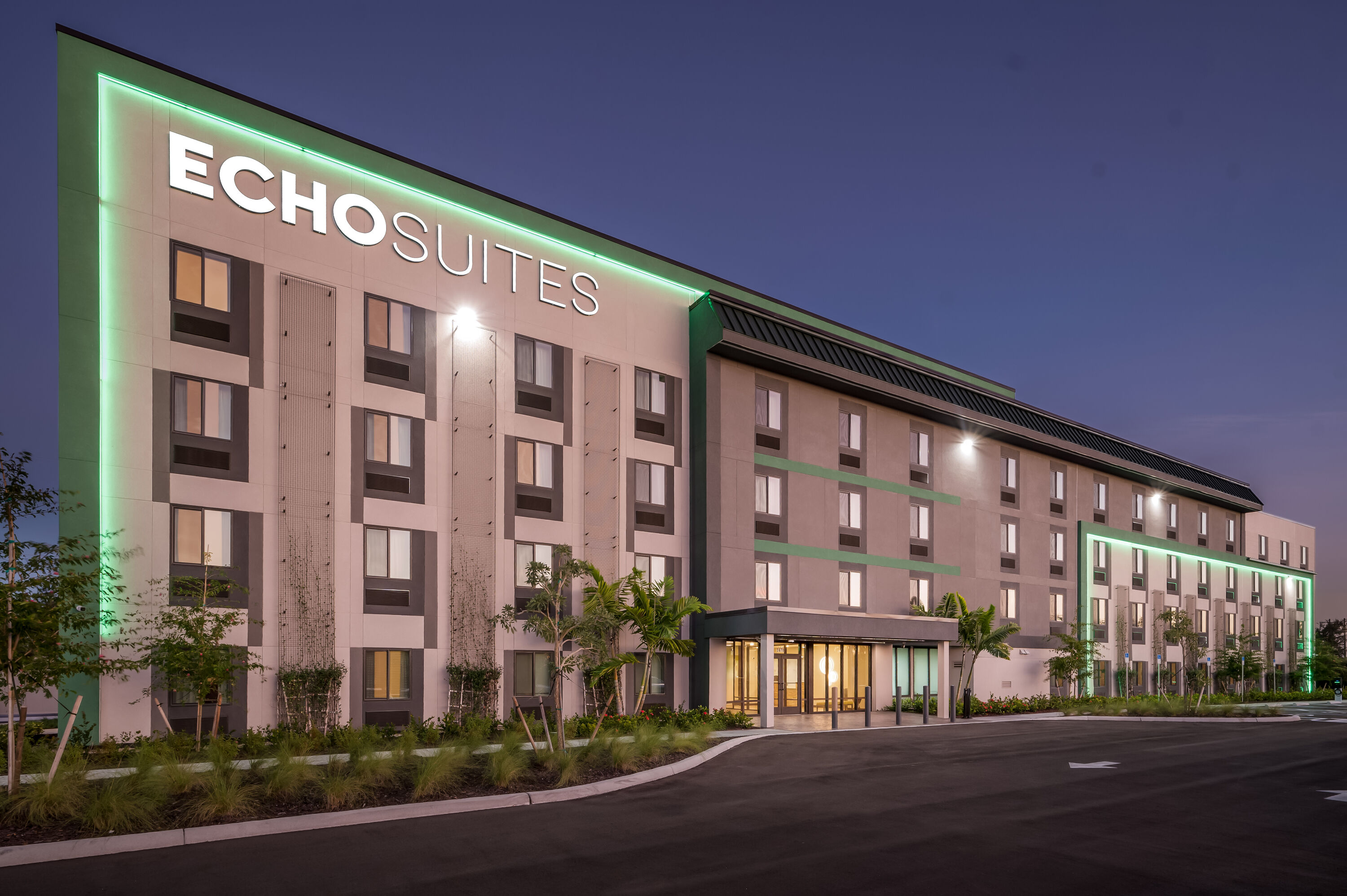 Exterior Night Image of ECHO Suites Extended Stay by Wyndham Naples hotel in Naples, Florida