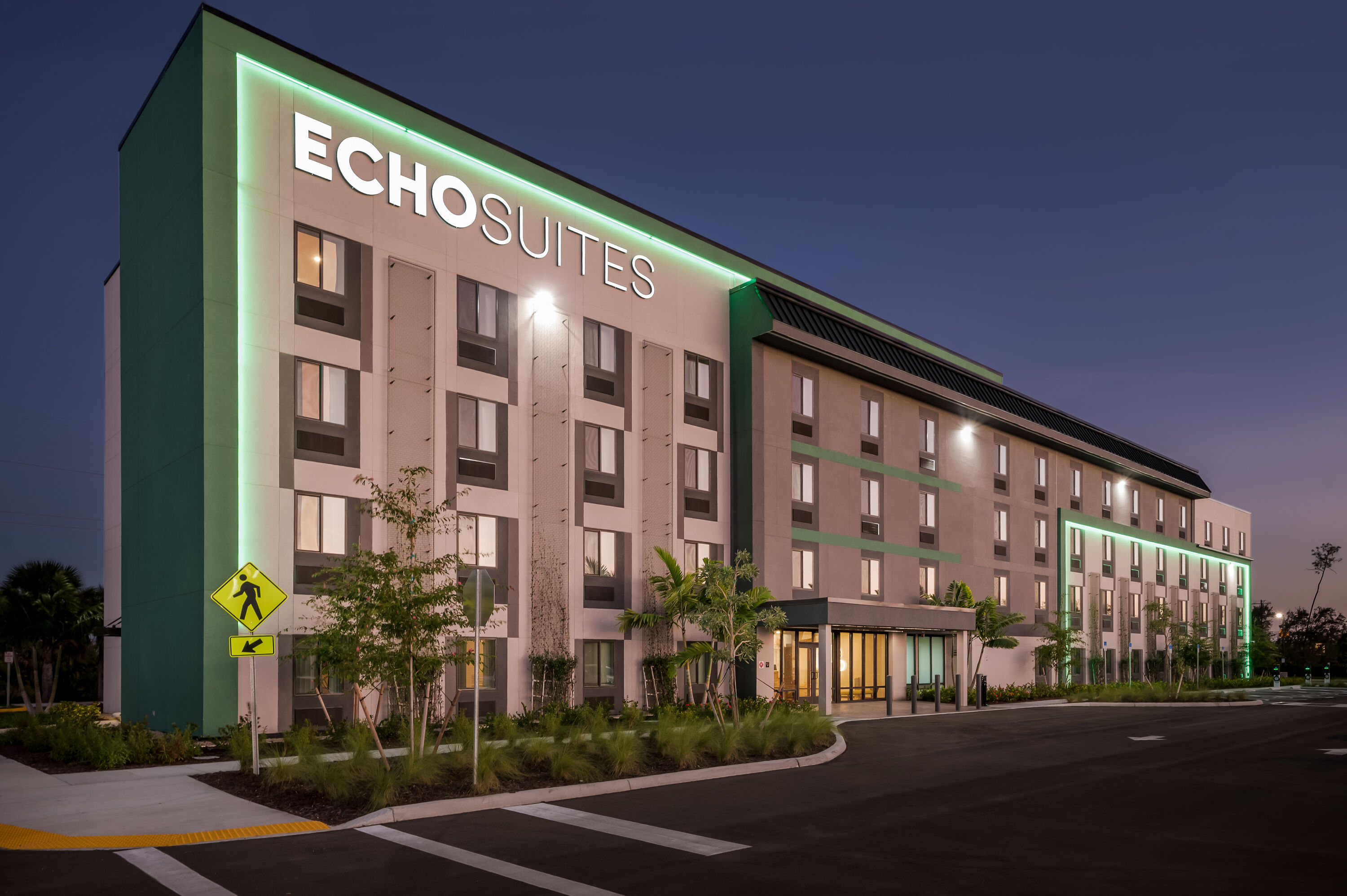 Exterior Night Image of ECHO Suites Extended Stay by Wyndham Naples hotel in Naples, Florida