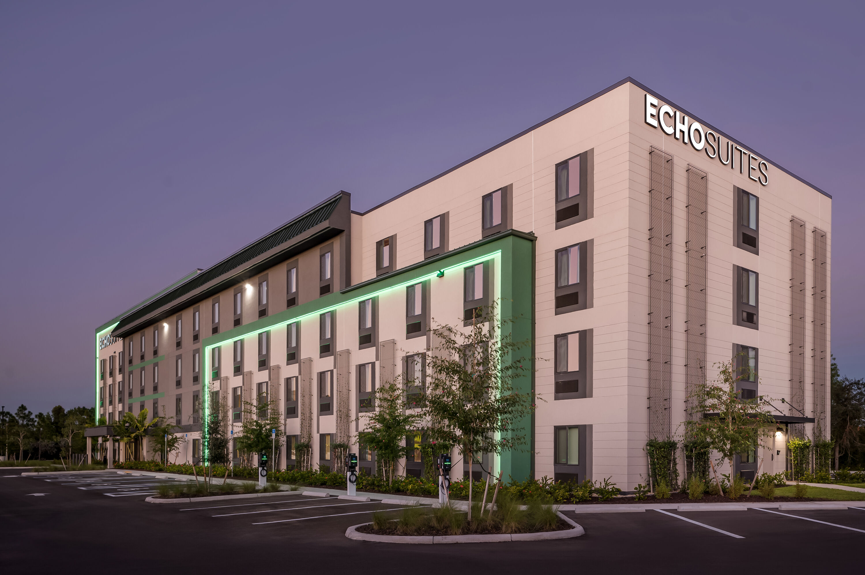 Exterior Night Image of ECHO Suites Extended Stay by Wyndham Naples hotel in Naples, Florida