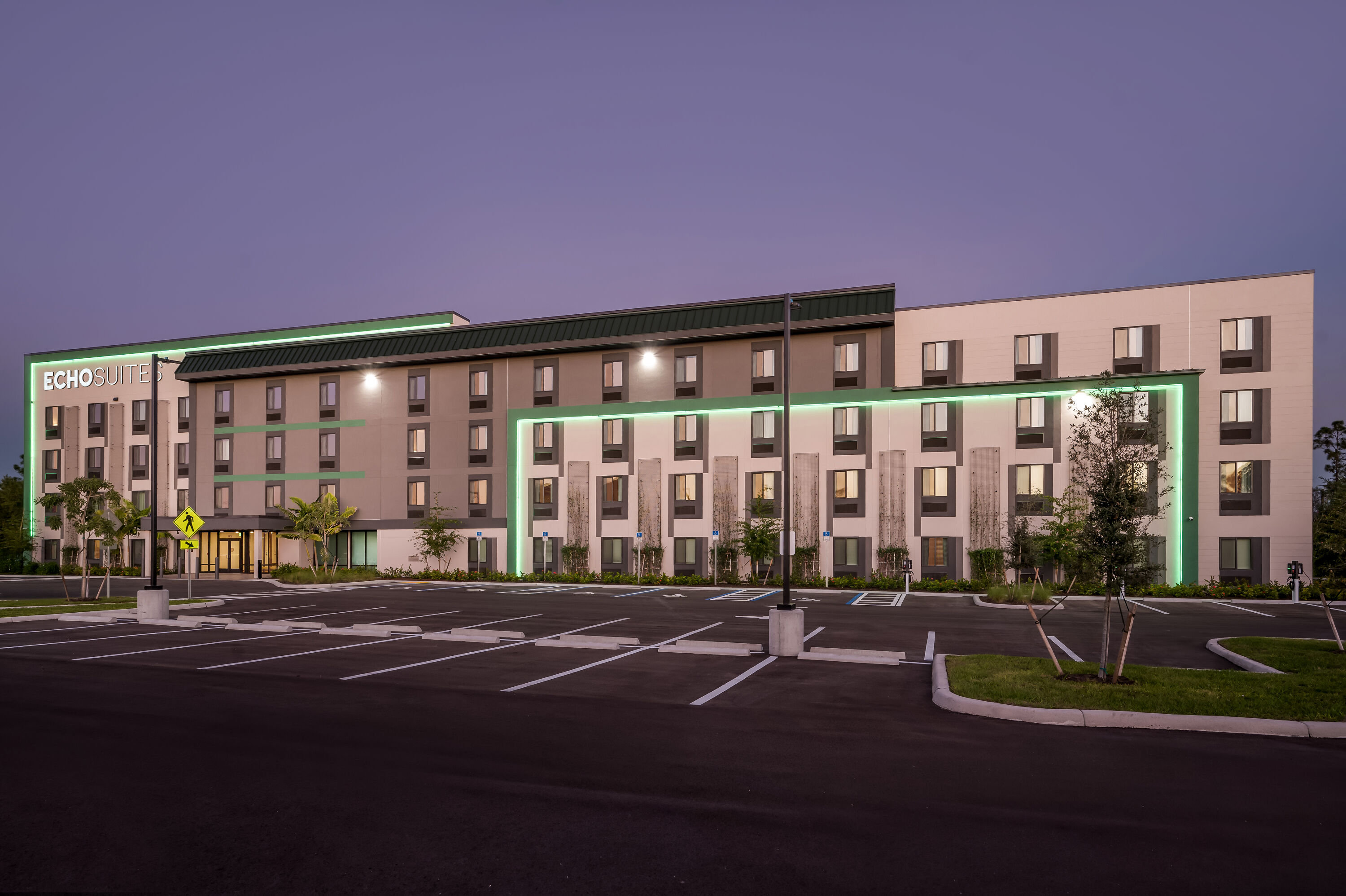Exterior Night Image of ECHO Suites Extended Stay by Wyndham Naples hotel in Naples, Florida