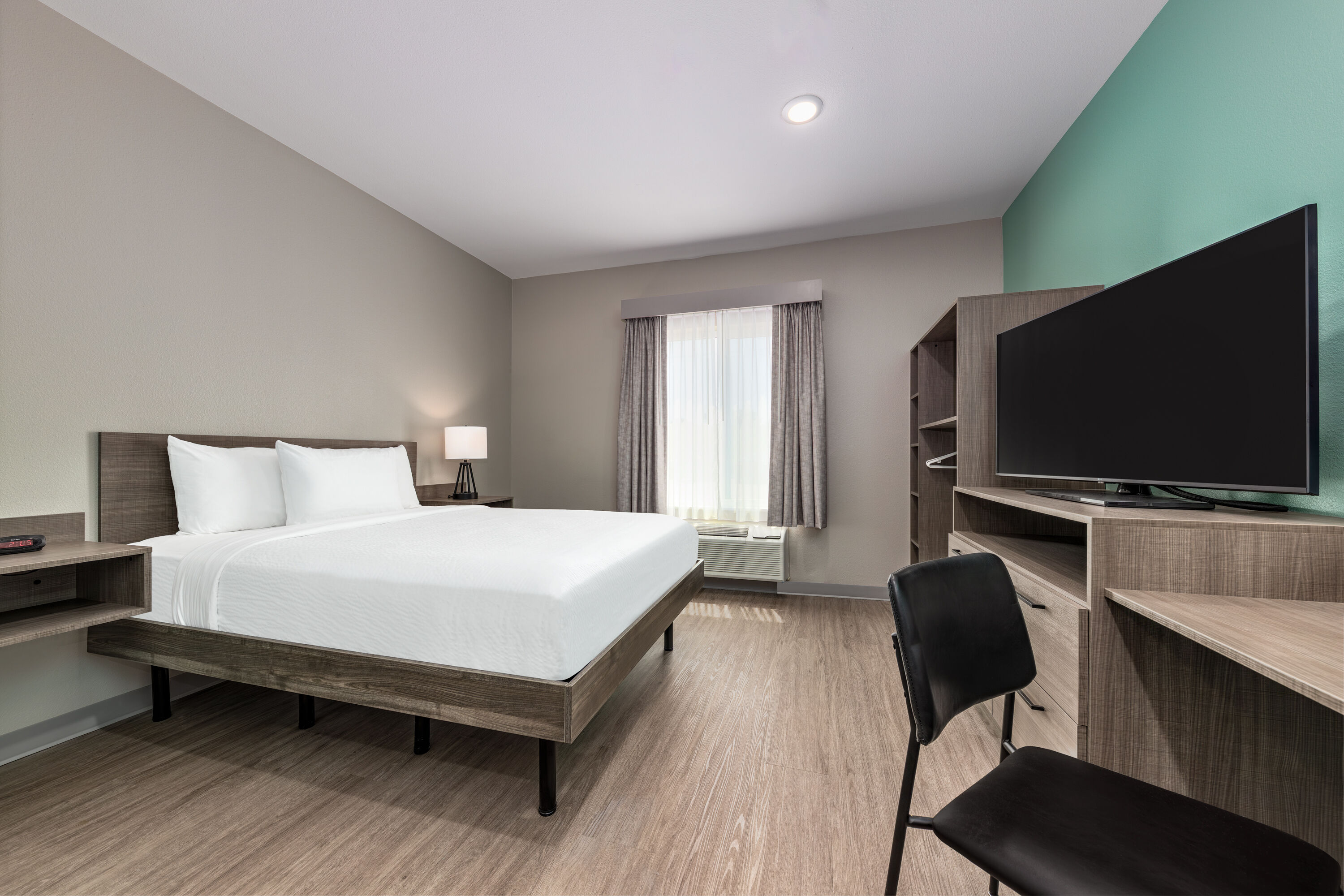 Guest room at the ECHO Suites Extended Stay by Wyndham Dallas Plano/Richardson in Plano, Texas