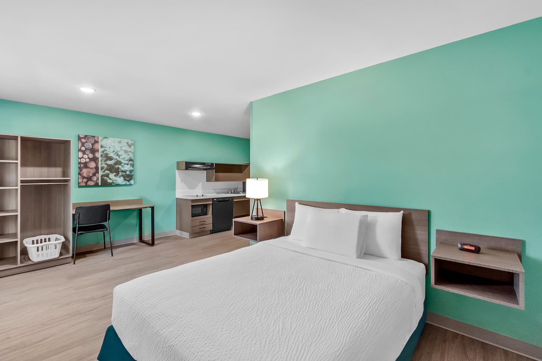 Queen bed guest room at the ECHO Suites Extended Stay by Wyndham Sterling in Sterling, Virginia