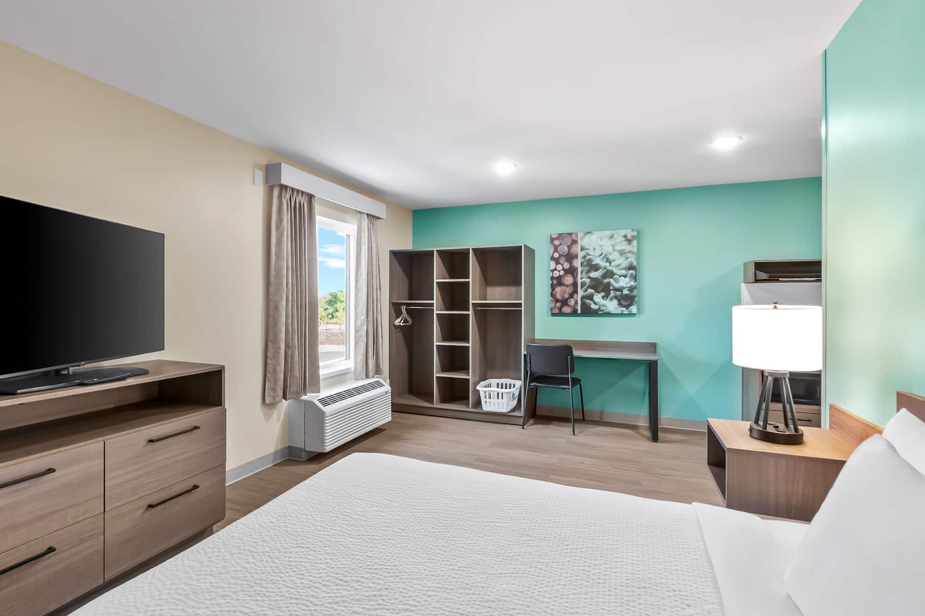 Queen bed guest room at the ECHO Suites Extended Stay by Wyndham Sterling in Sterling, Virginia