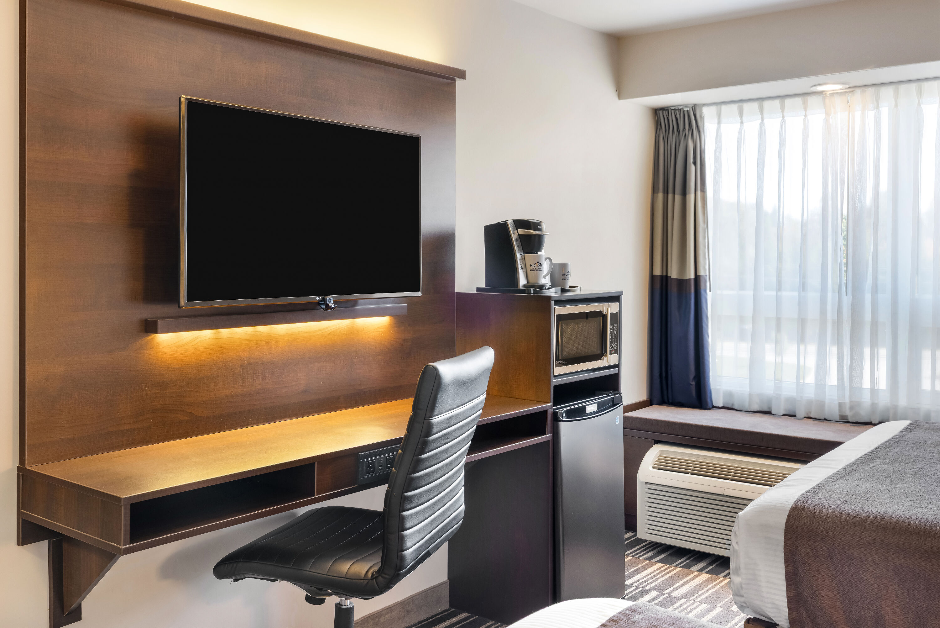 Queen bed guest room at the Microtel Inn & Suites by Wyndham Mont Tremblant in Mont-Tremblant, Quebec