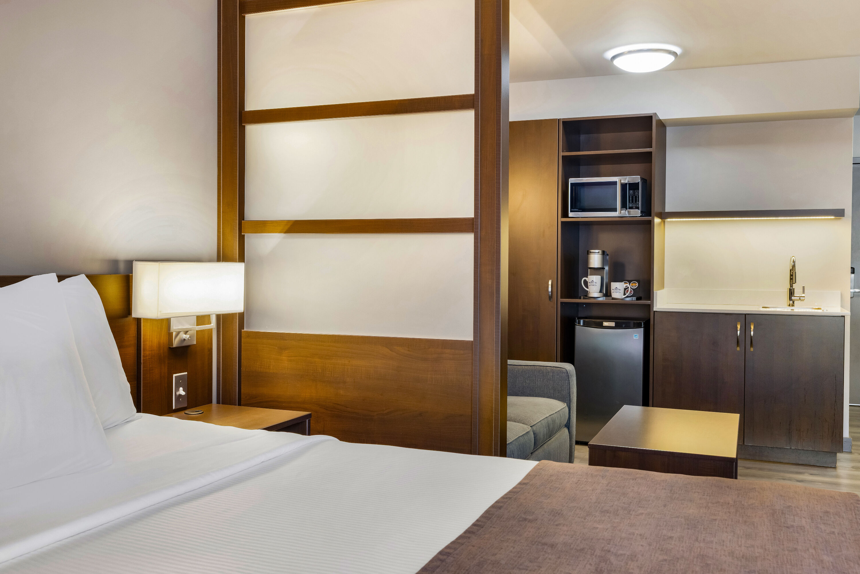 Queen bed guest room at the Microtel Inn & Suites by Wyndham Mont Tremblant in Mont-Tremblant, Quebec