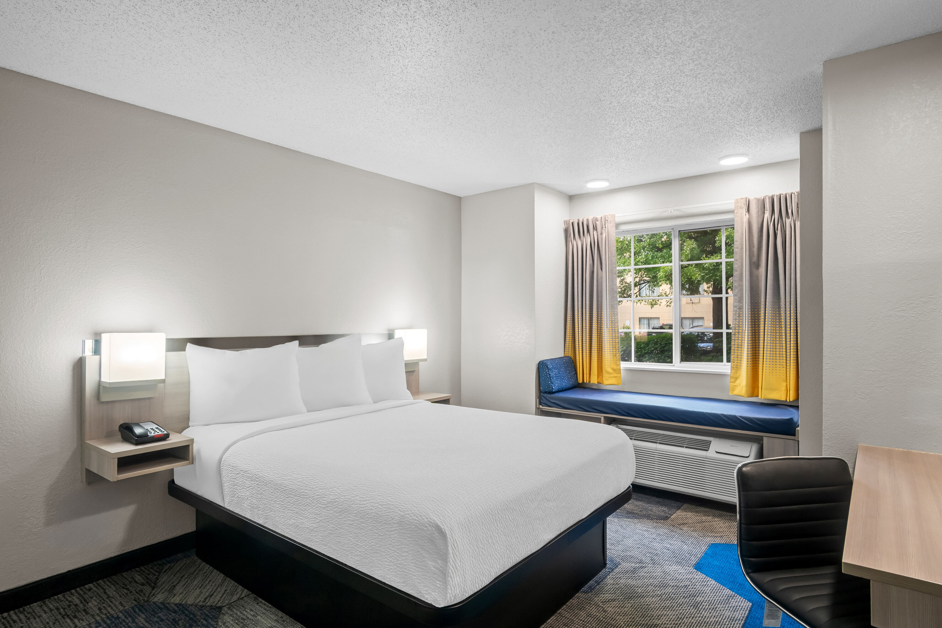 Queen bed guest room at the Microtel Inn & Suites by Wyndham Georgetown in Georgetown, Kentucky