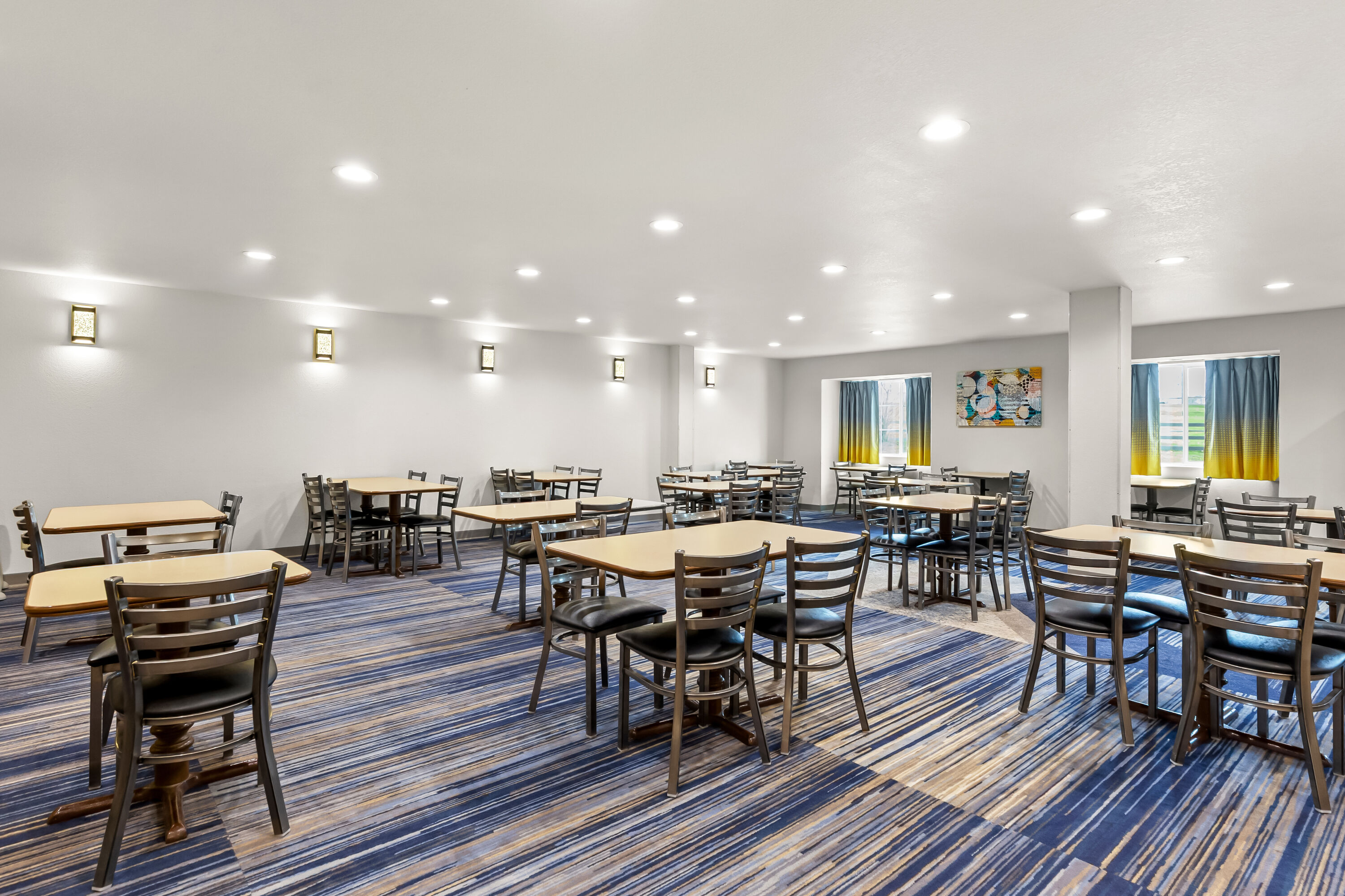 Microtel Inn & Suites by Wyndham Sainte Genevieve restaurant breakfast area with seating in Sainte Genevieve, Missouri