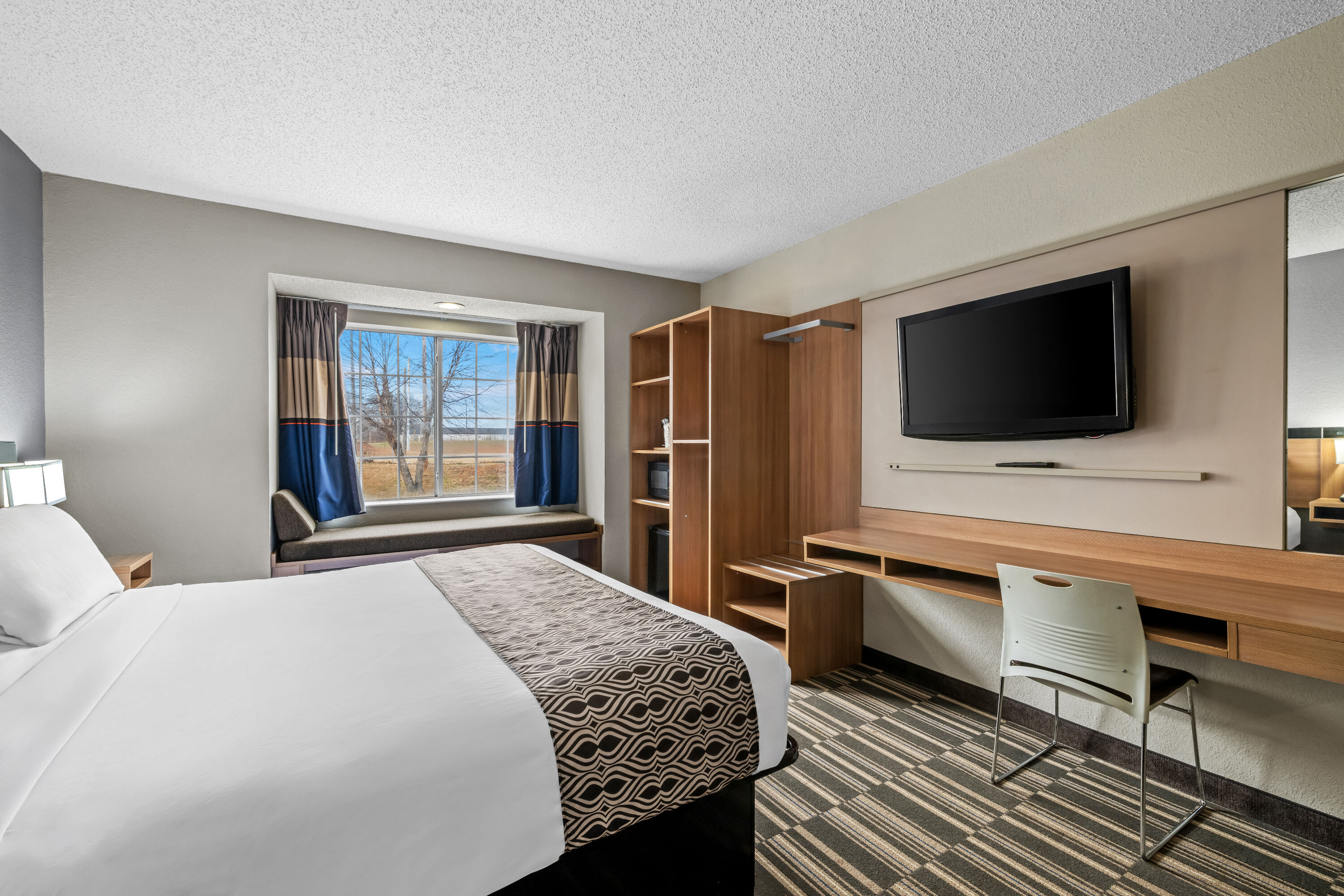 Queen bed guest room at the Microtel Inn & Suites by Wyndham Statesville in Statesville, North Carolina