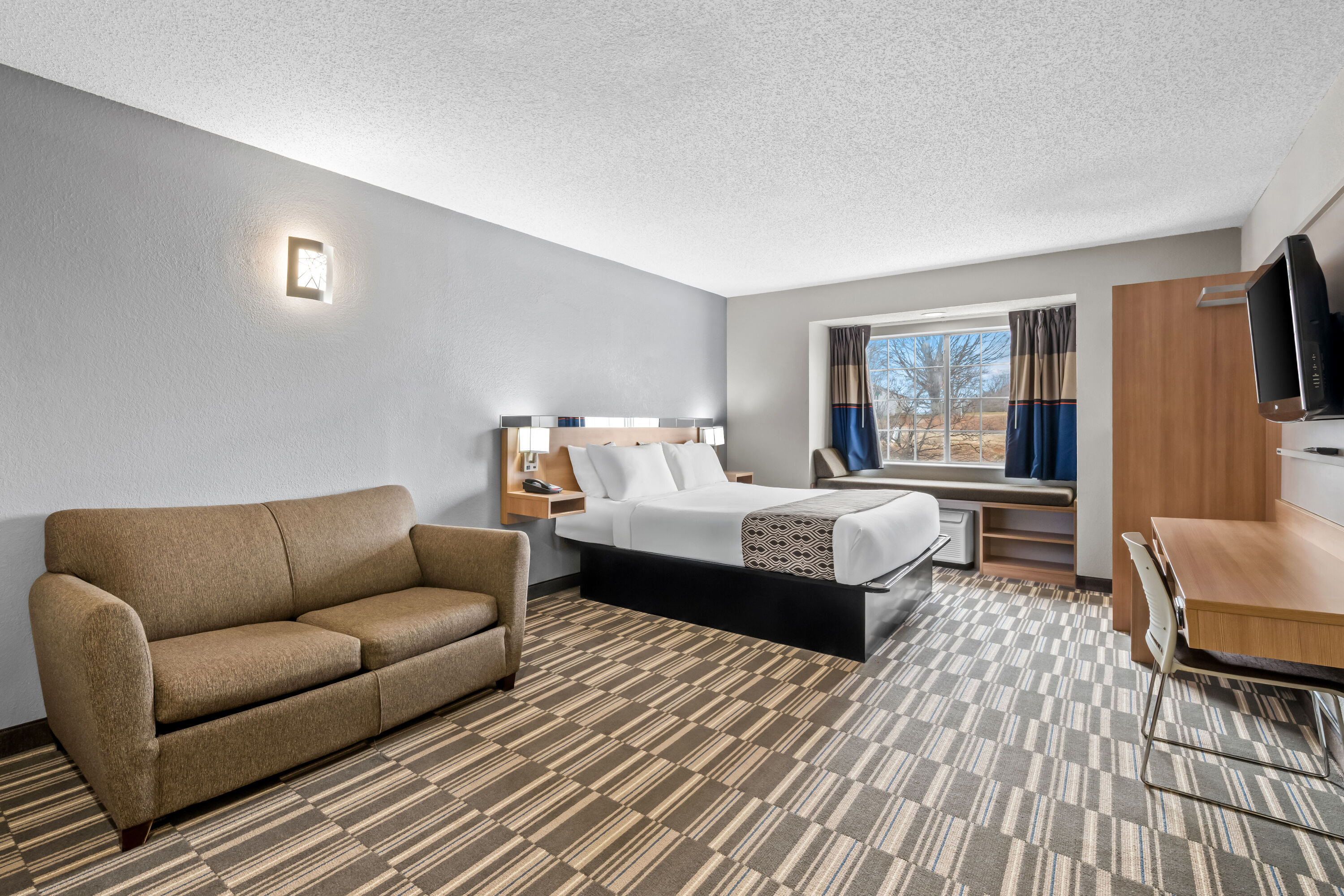 Queen bed guest room at the Microtel Inn & Suites by Wyndham Statesville in Statesville, North Carolina