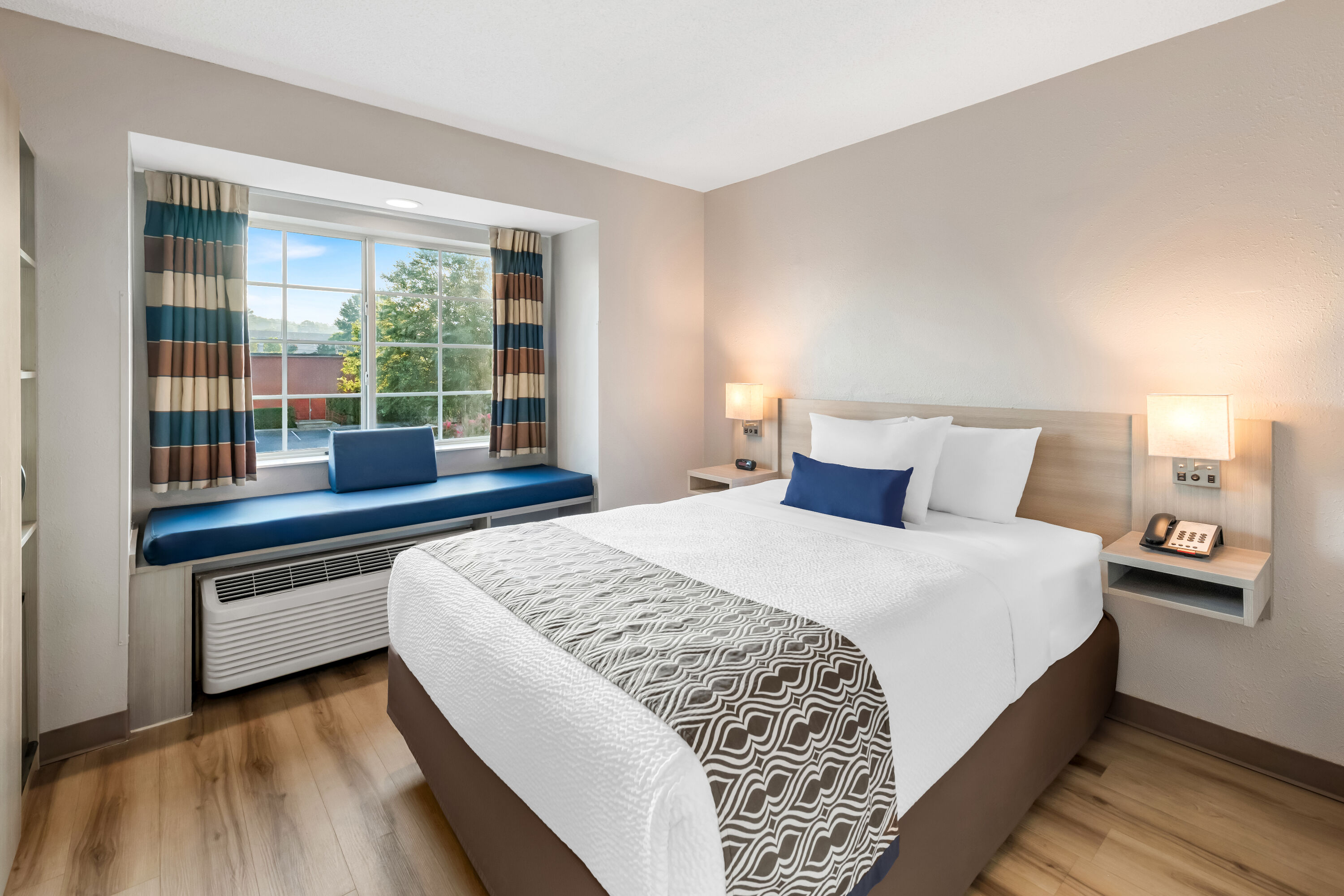 Queen bed guest room at the Microtel Inn & Suites by Wyndham Greenville / Woodruff Rd in Greenville, South Carolina