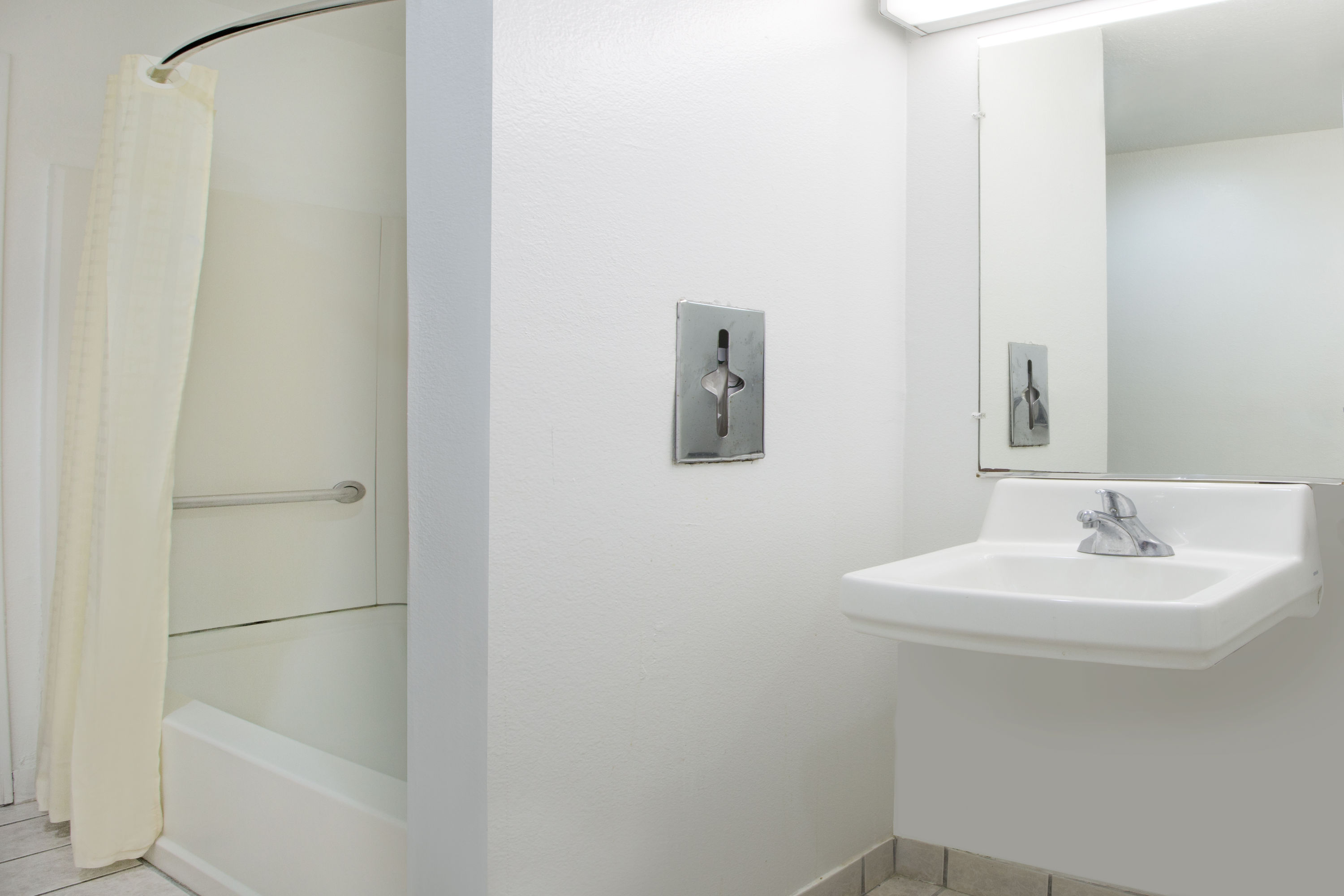 Guest room bath at the Microtel Inn & Suites by Wyndham Garland/Dallas in Garland, Texas