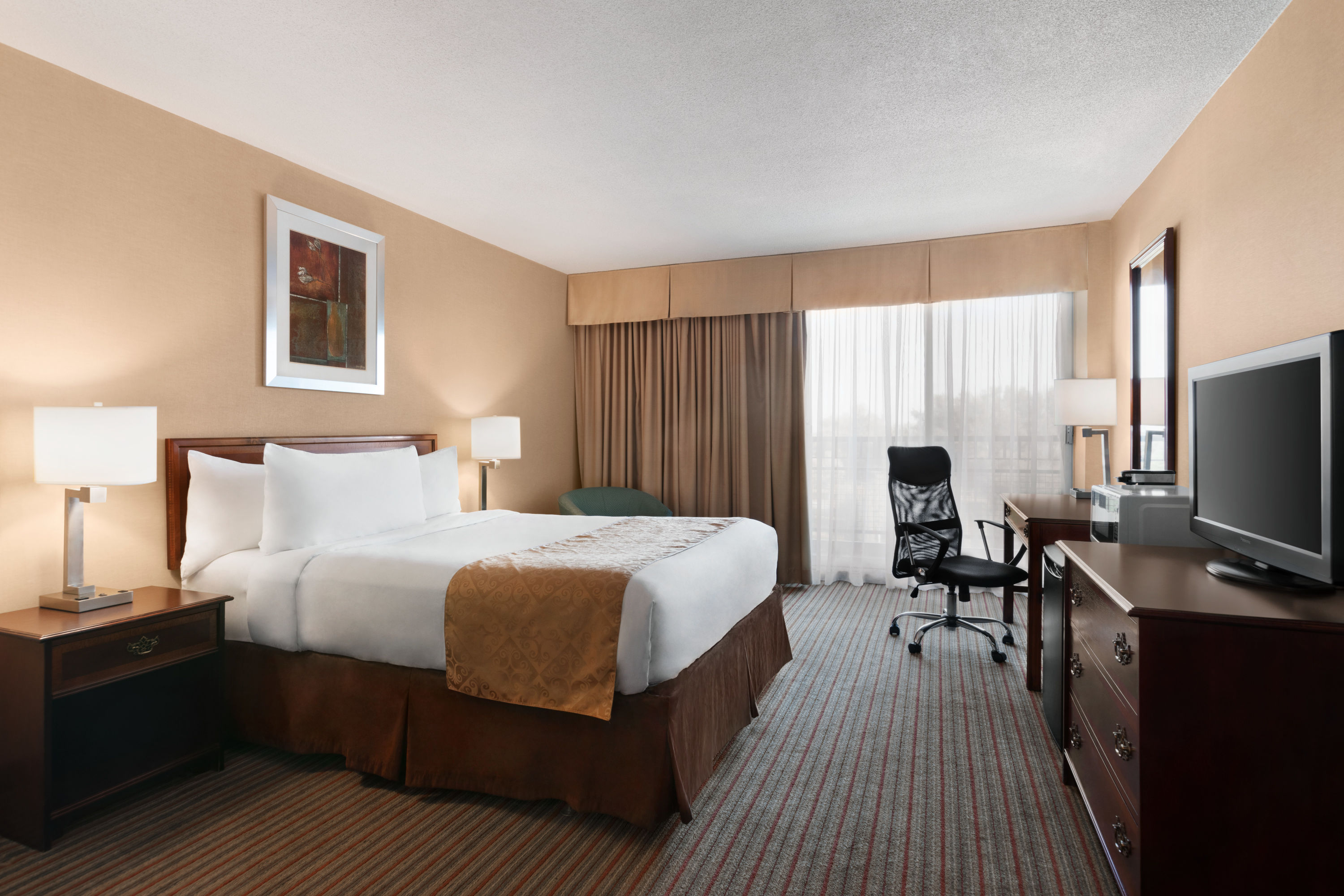 Guest room at the Ramada by Wyndham Belleville Harbourview Conference Centre in Belleville, Ontario