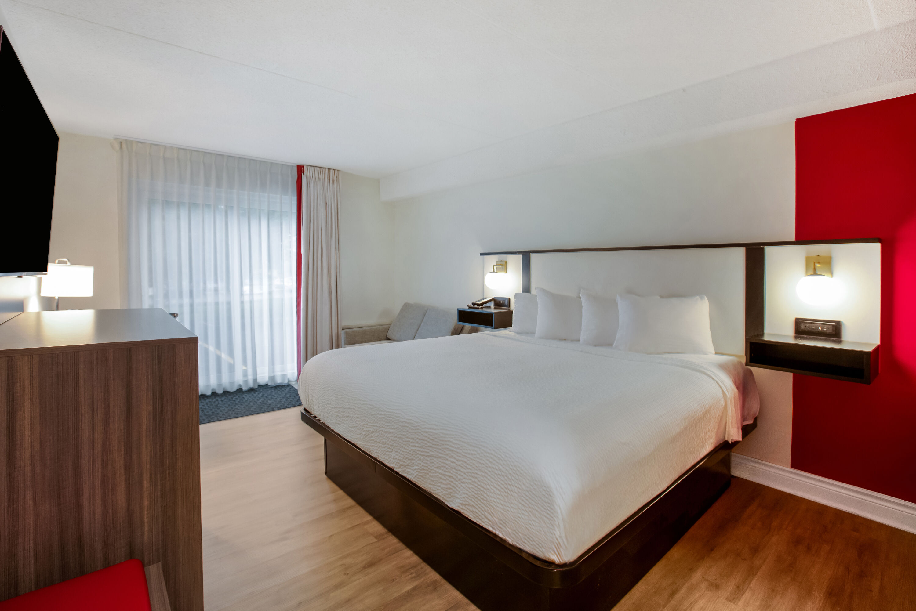 King bed guest room at the Ramada by Wyndham Kingston in Kingston, Ontario