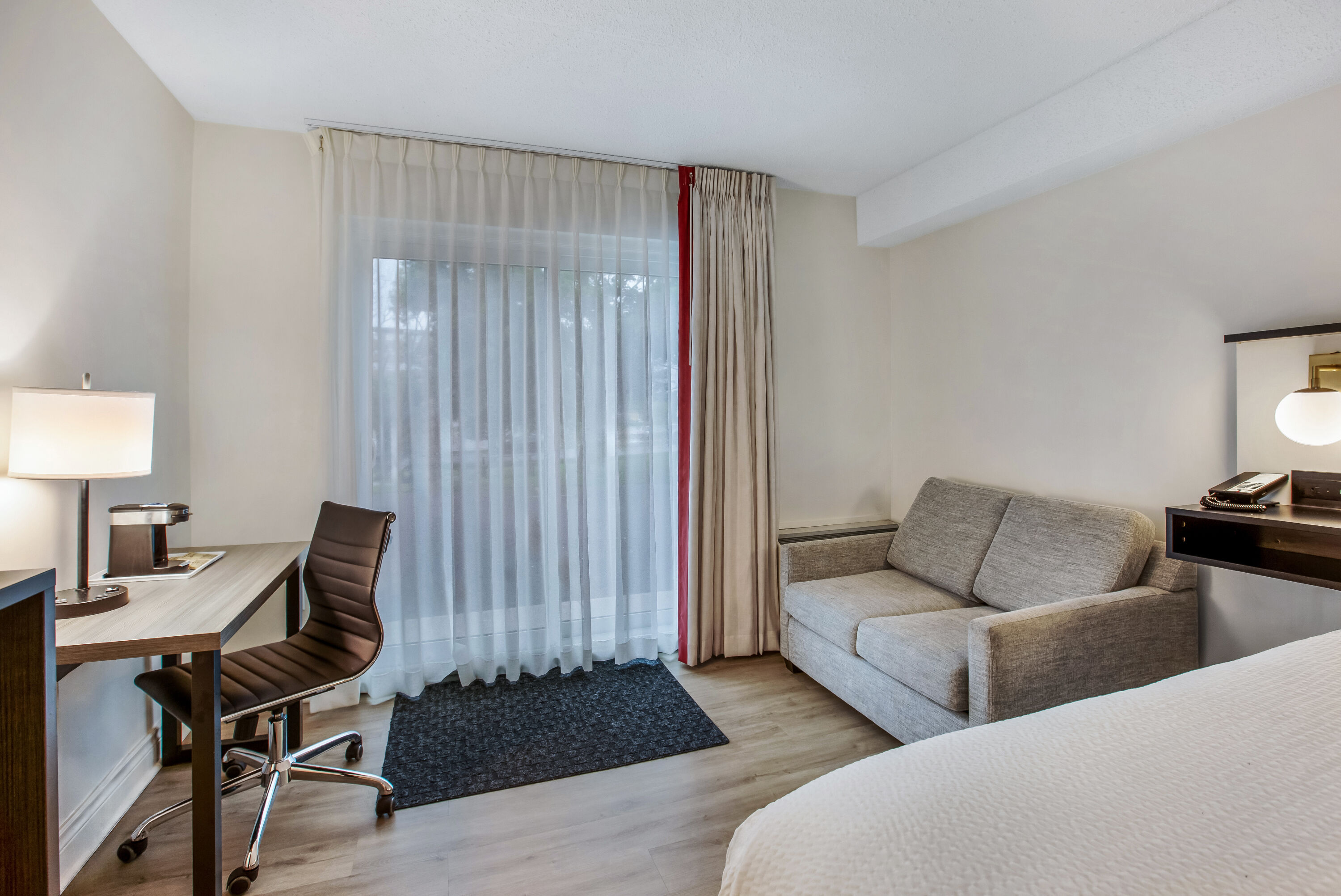 King bed guest room at the Ramada by Wyndham Kingston in Kingston, Ontario