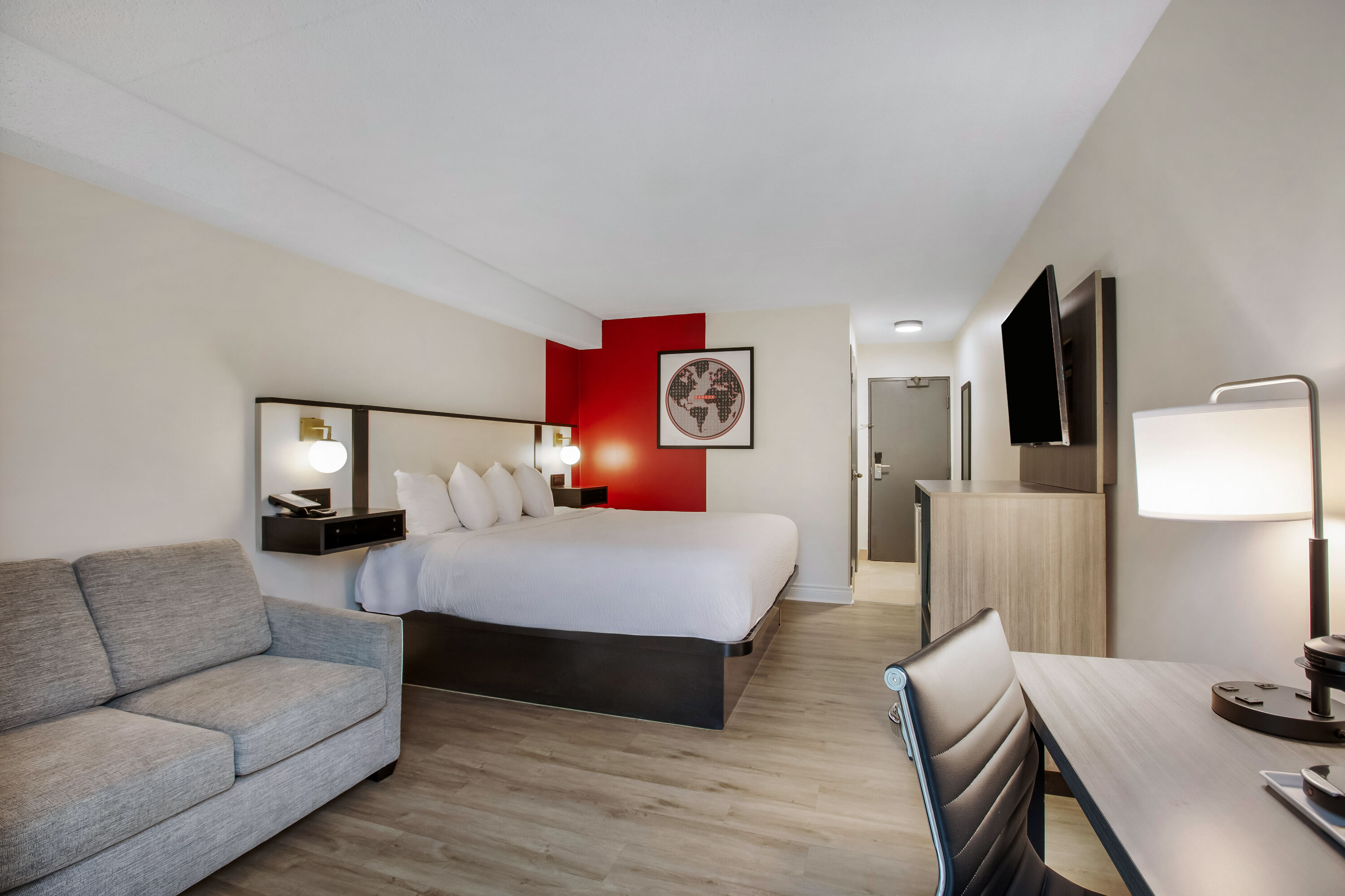 King bed guest room at the Ramada by Wyndham Kingston in Kingston, Ontario