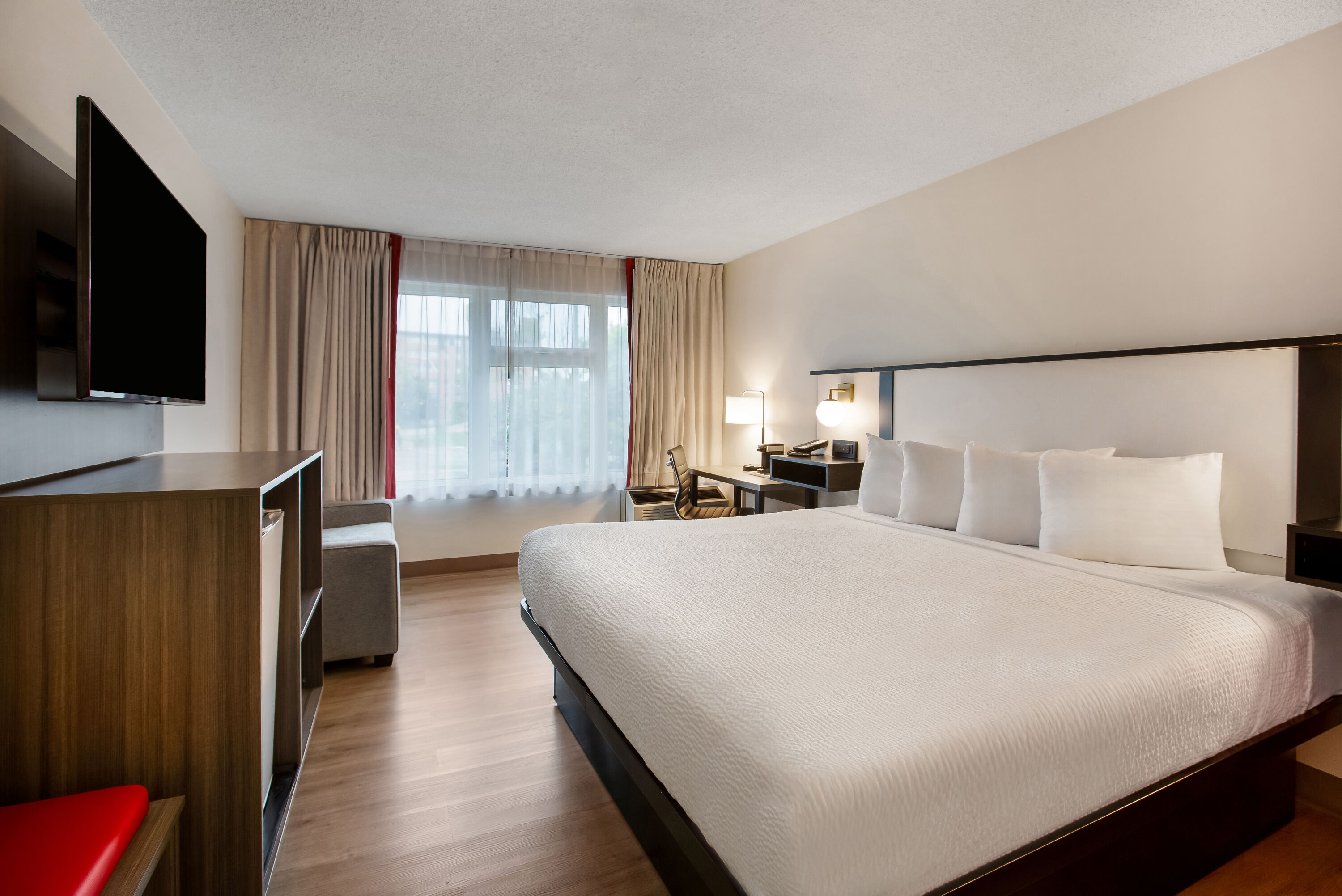 King bed guest room at the Ramada by Wyndham Kingston in Kingston, Ontario