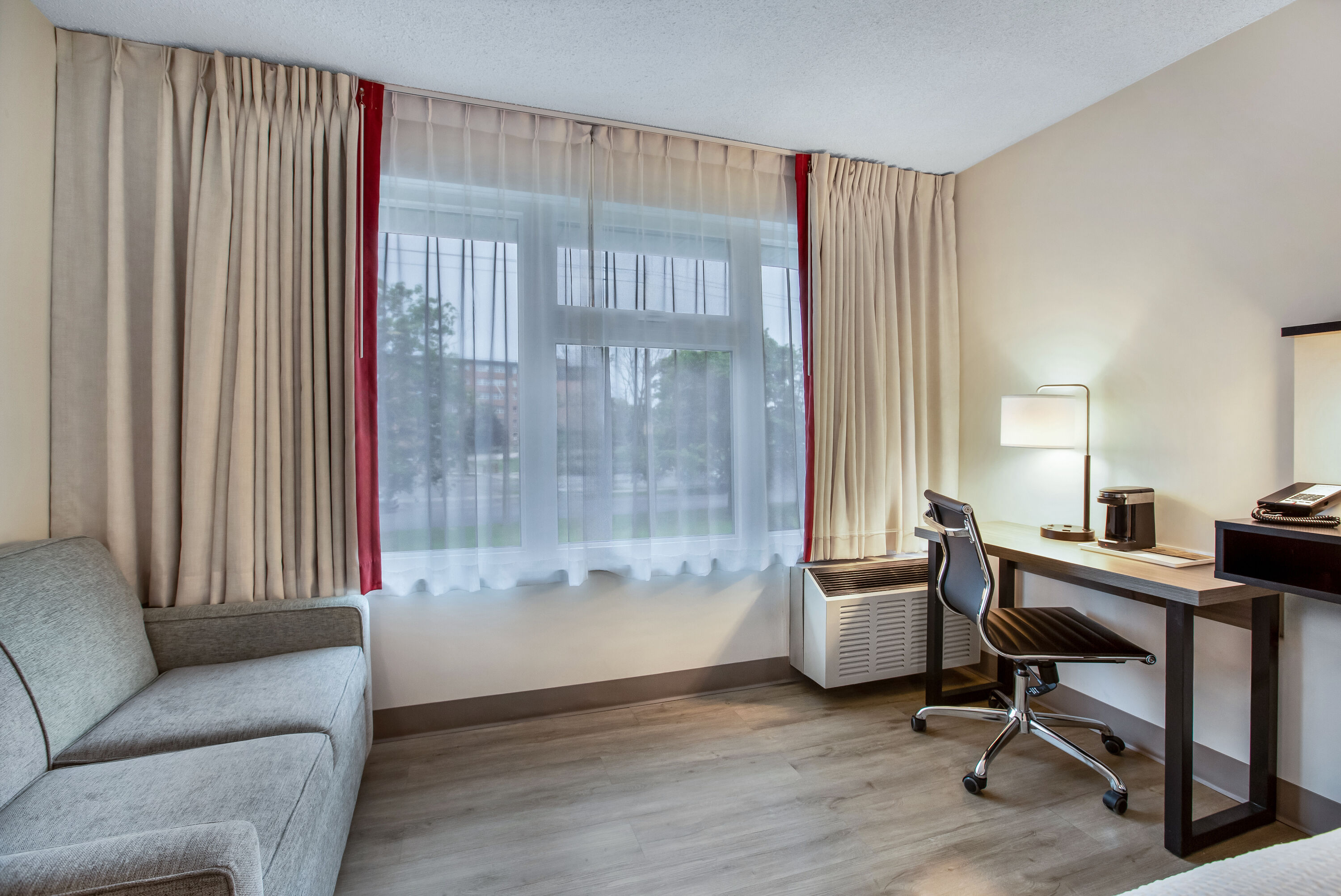 King bed guest room at the Ramada by Wyndham Kingston in Kingston, Ontario