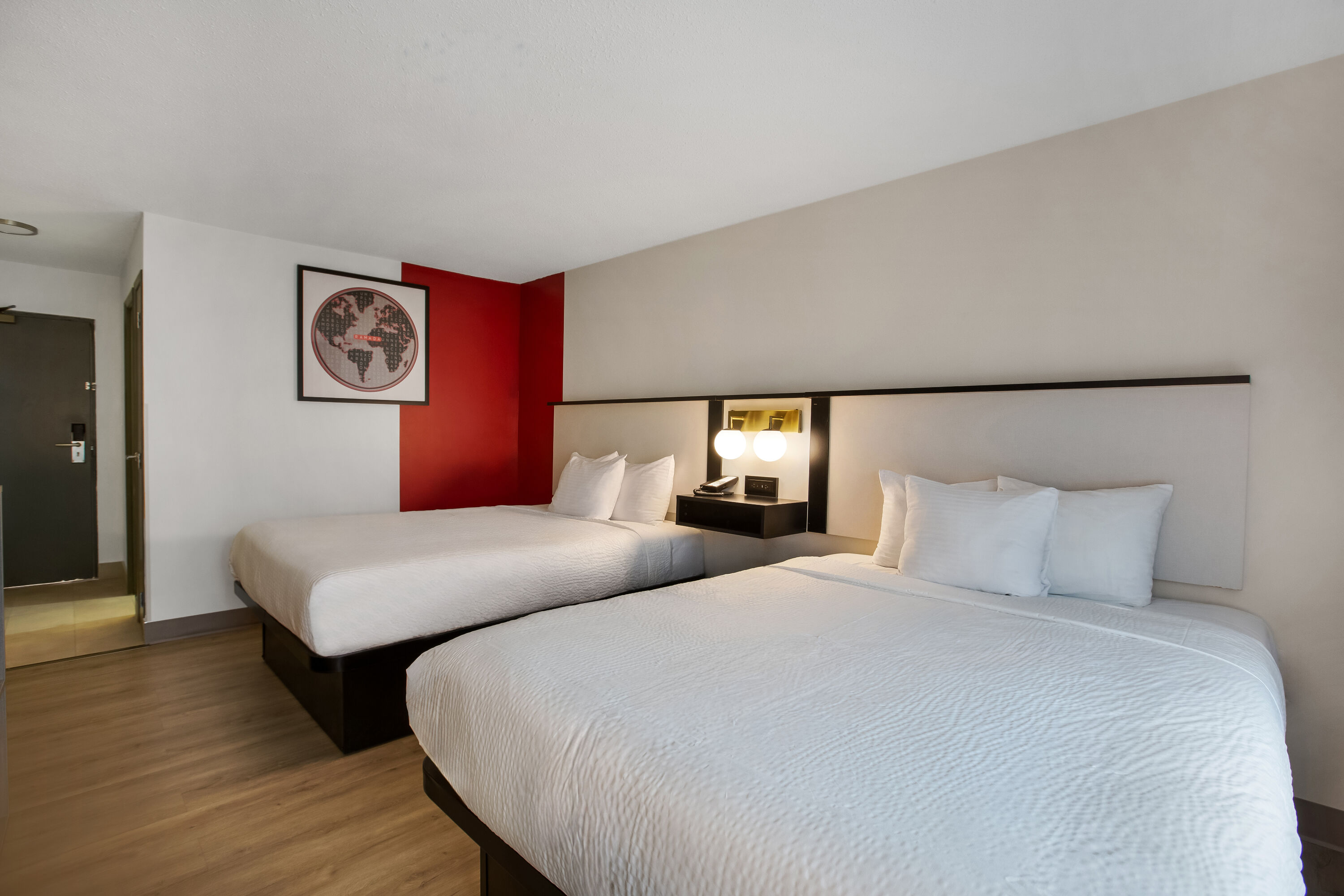 Queen bed guest room at the Ramada by Wyndham Kingston in Kingston, Ontario