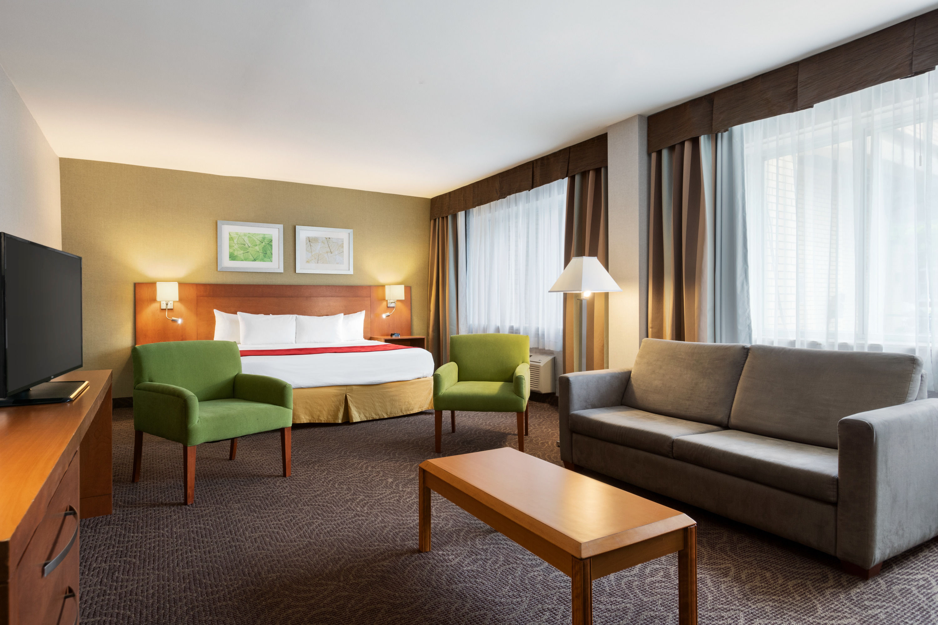 King bed guest room at the Ramada Plaza by Wyndham Montreal in Montreal, Quebec