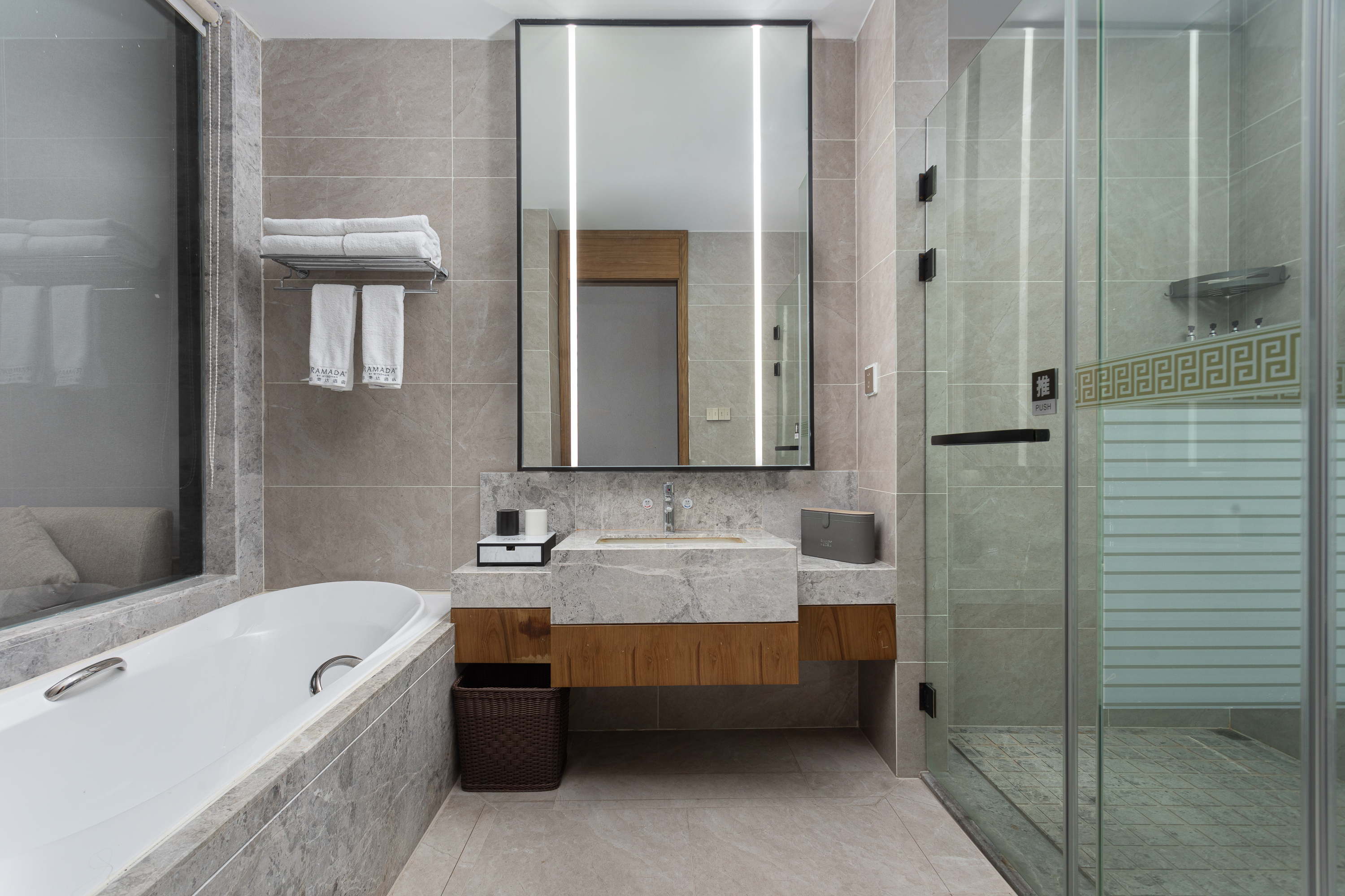 Guest room bath at the Ramada by Wyndham Wuhan Wangjiawan in Wuhan, Other than US/Canada