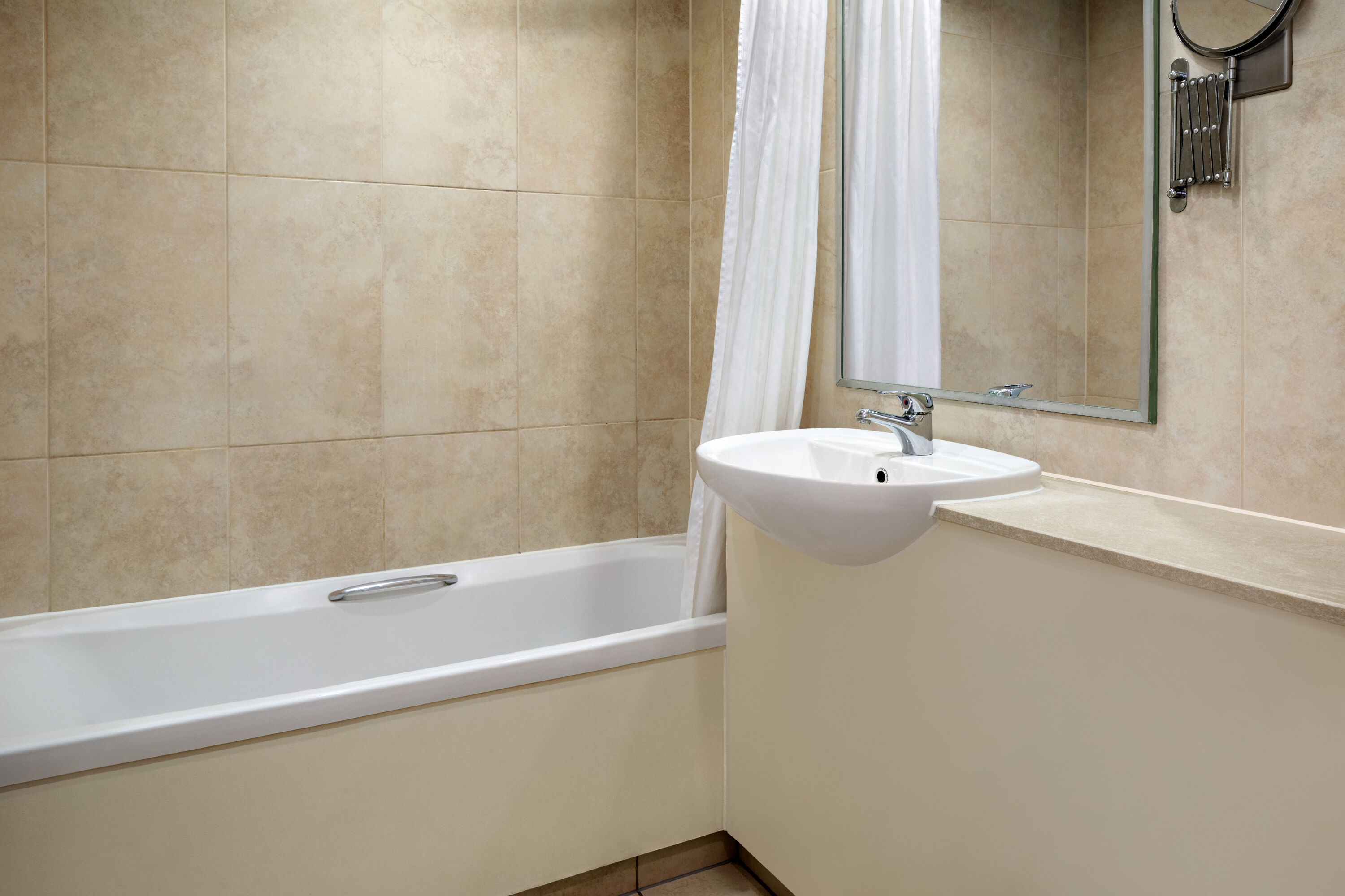 Guest room bath at the Ramada by Wyndham Cheltenham in Cheltenham, Other than US/Canada