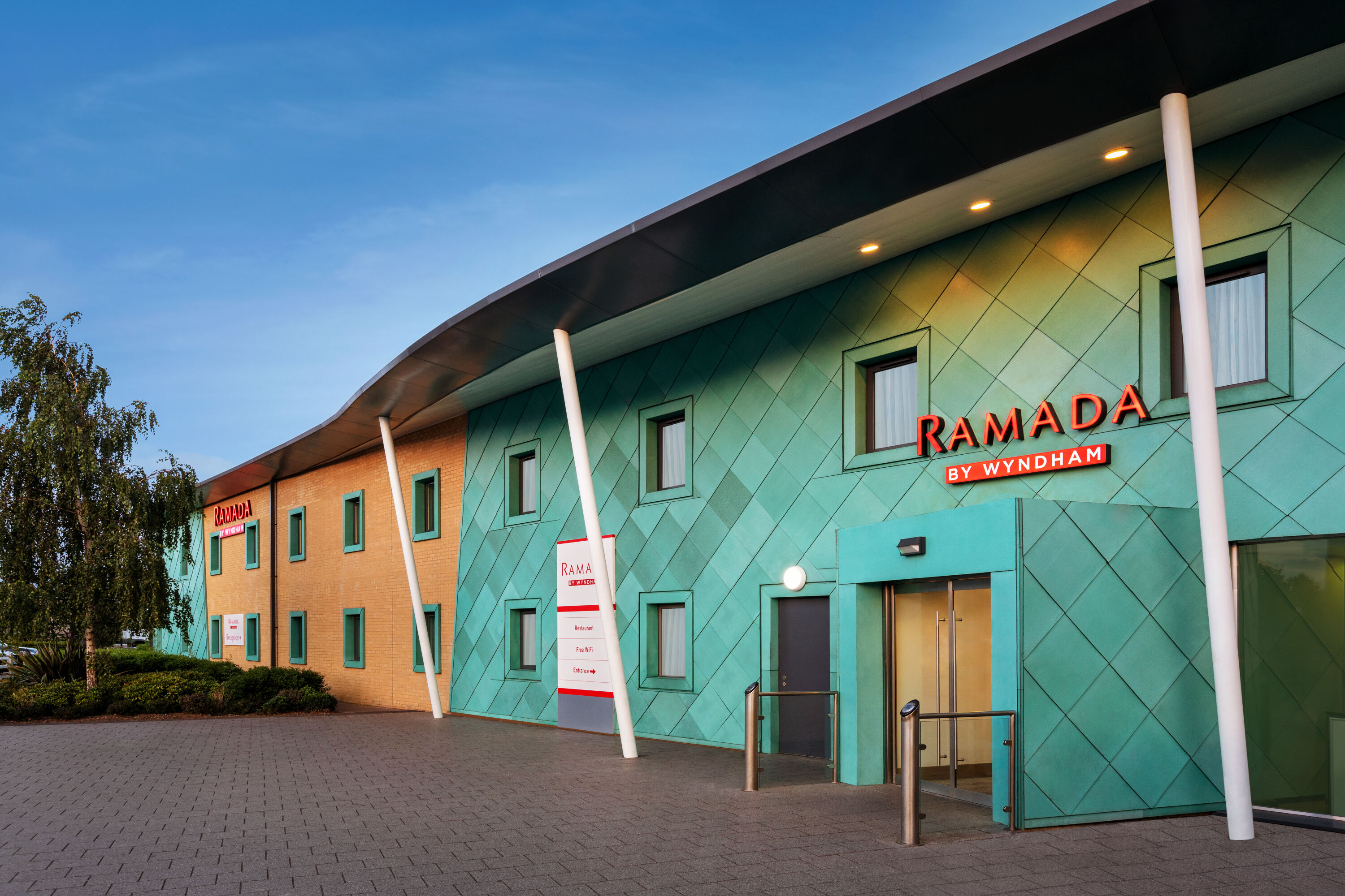 Exterior Dusk Image of Ramada by Wyndham Cobham hotel in Cobham, Other than US/Canada