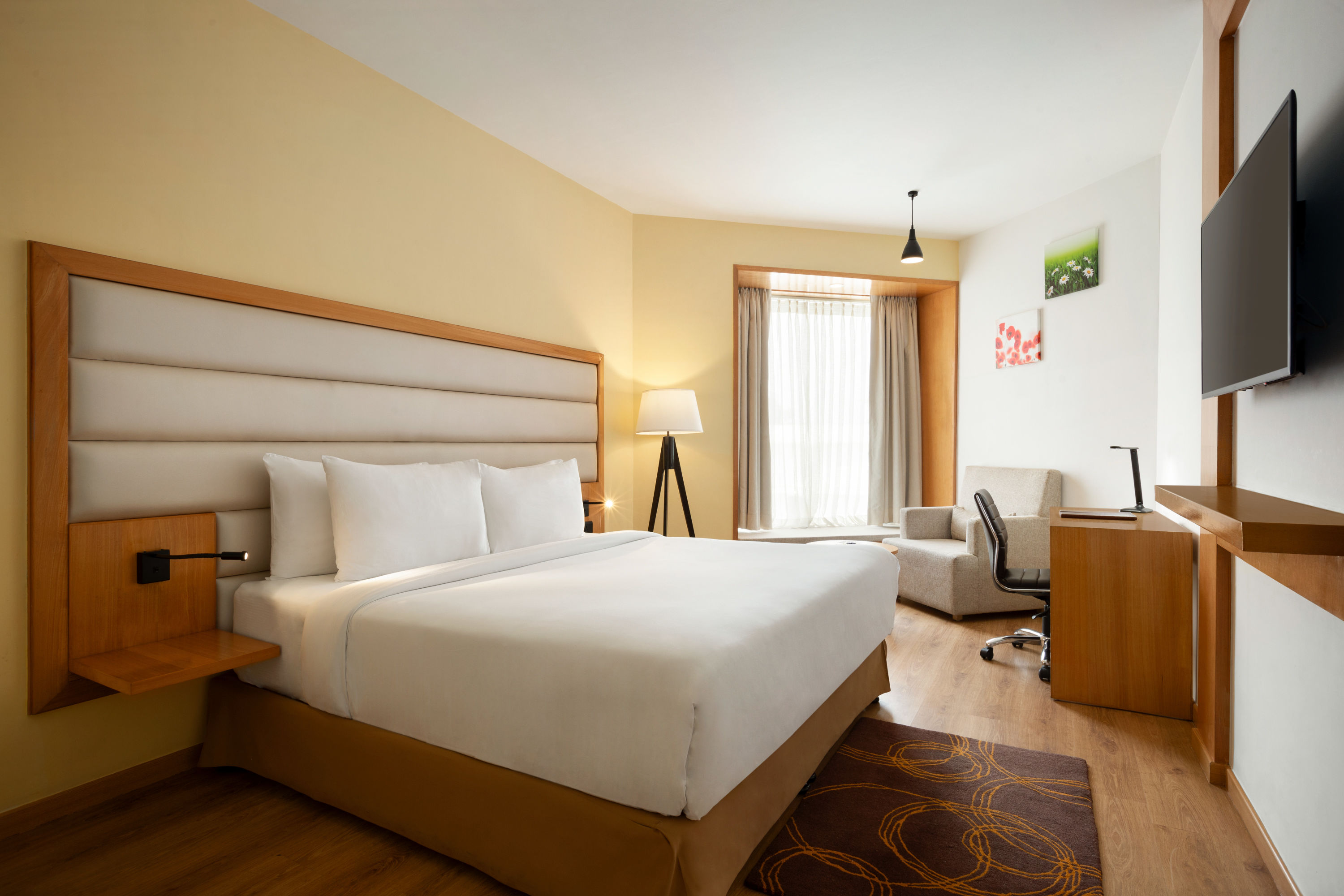 King bed guest room at the Ramada by Wyndham Dehradun Chakrata Road in Dehradun, Other than US/Canada