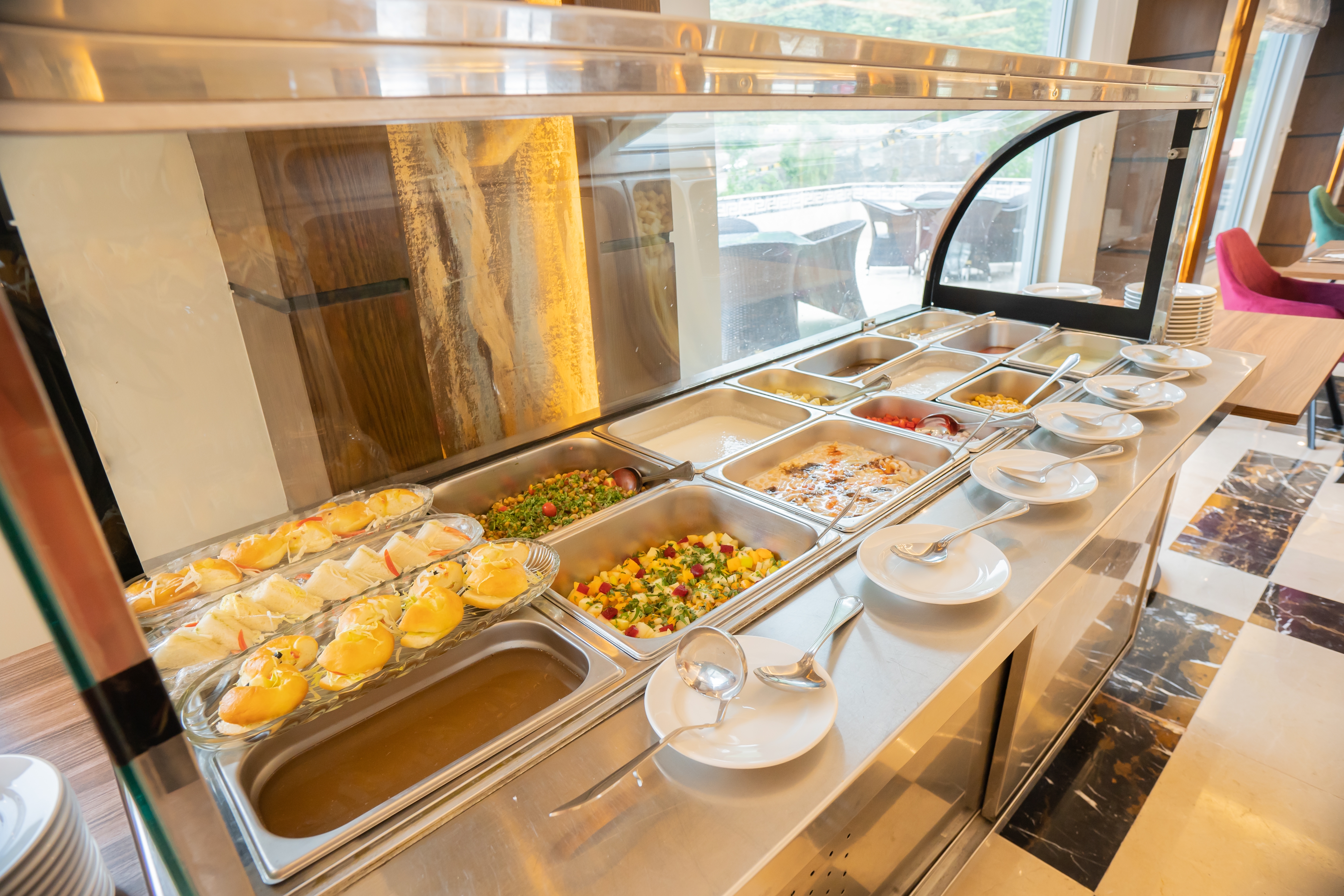 Ramada by Wyndham Murree Lower Topa Resort restaurant breakfast area with seating in Lower Topa, Murree, Other than US/Canada