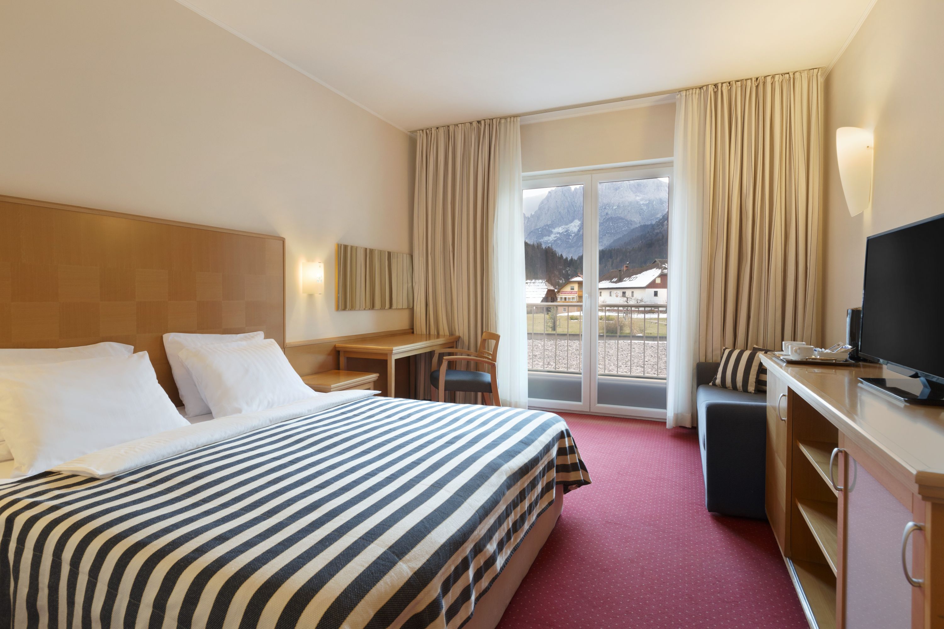 Guest room at the Ramada Hotel & Suites by Wyndham Kranjska Gora in Kranjska Gora, Other than US/Canada