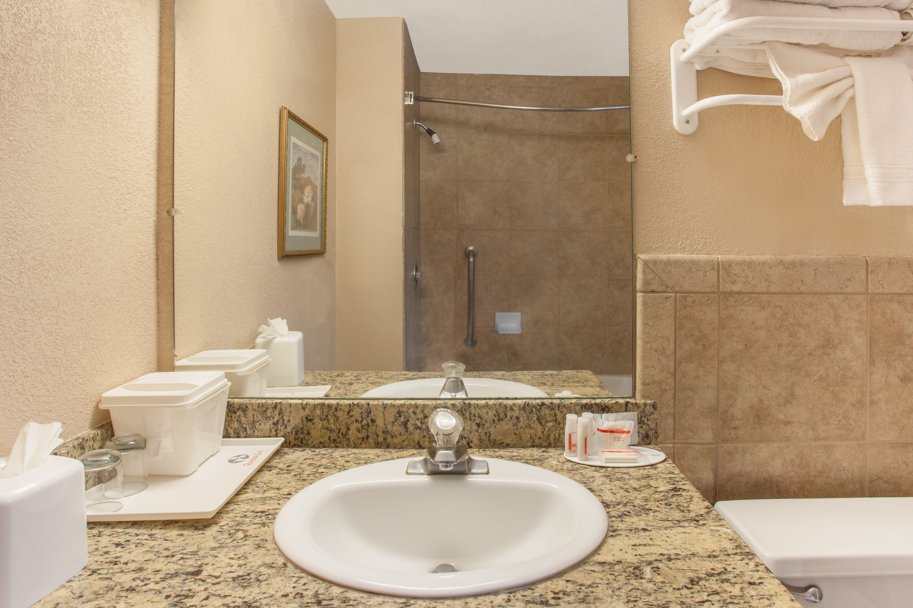 Guest room bath at the Ramada by Wyndham Fresno North in Fresno, California