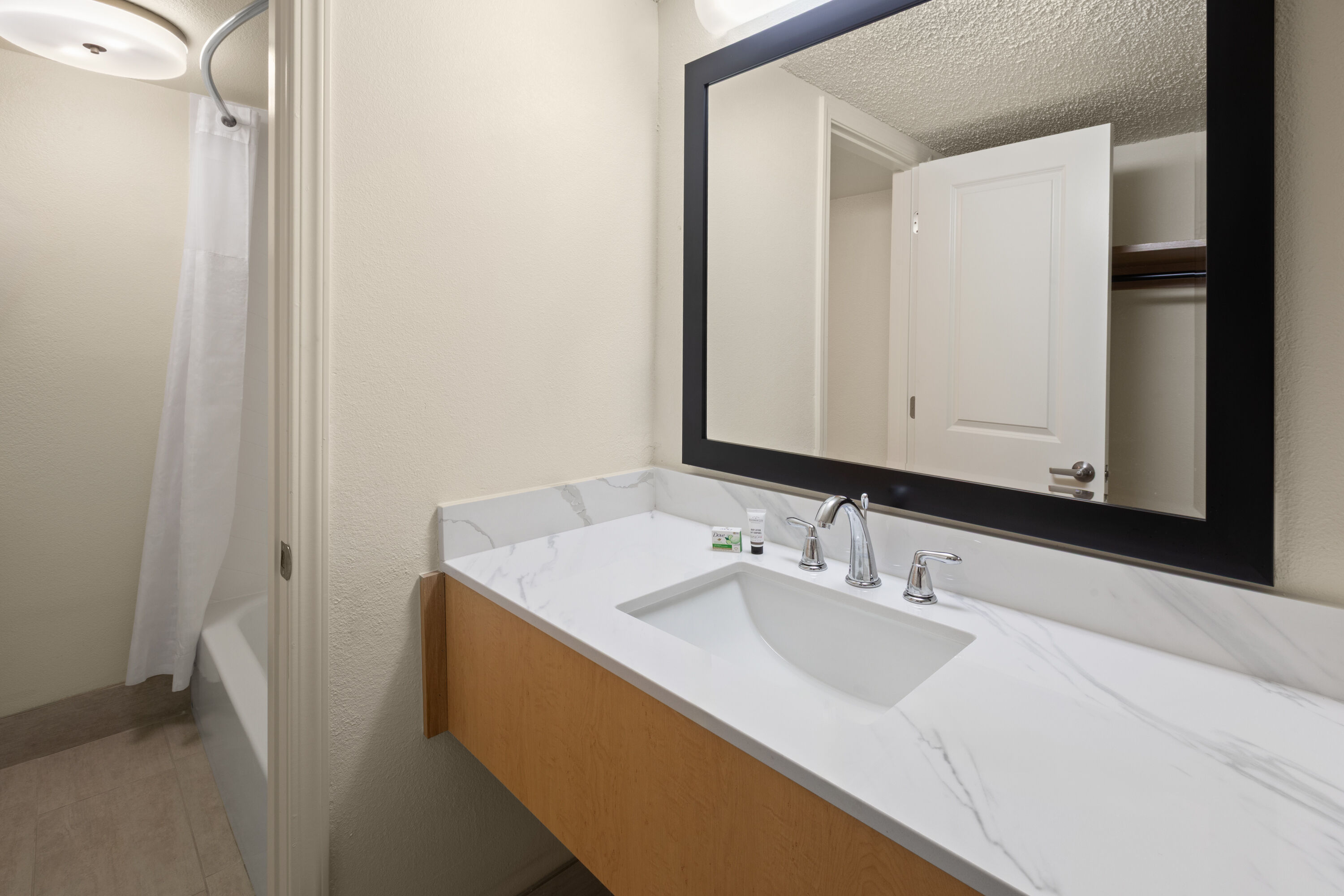 Guest room bath at the Ramada by Wyndham Merced in Merced, California