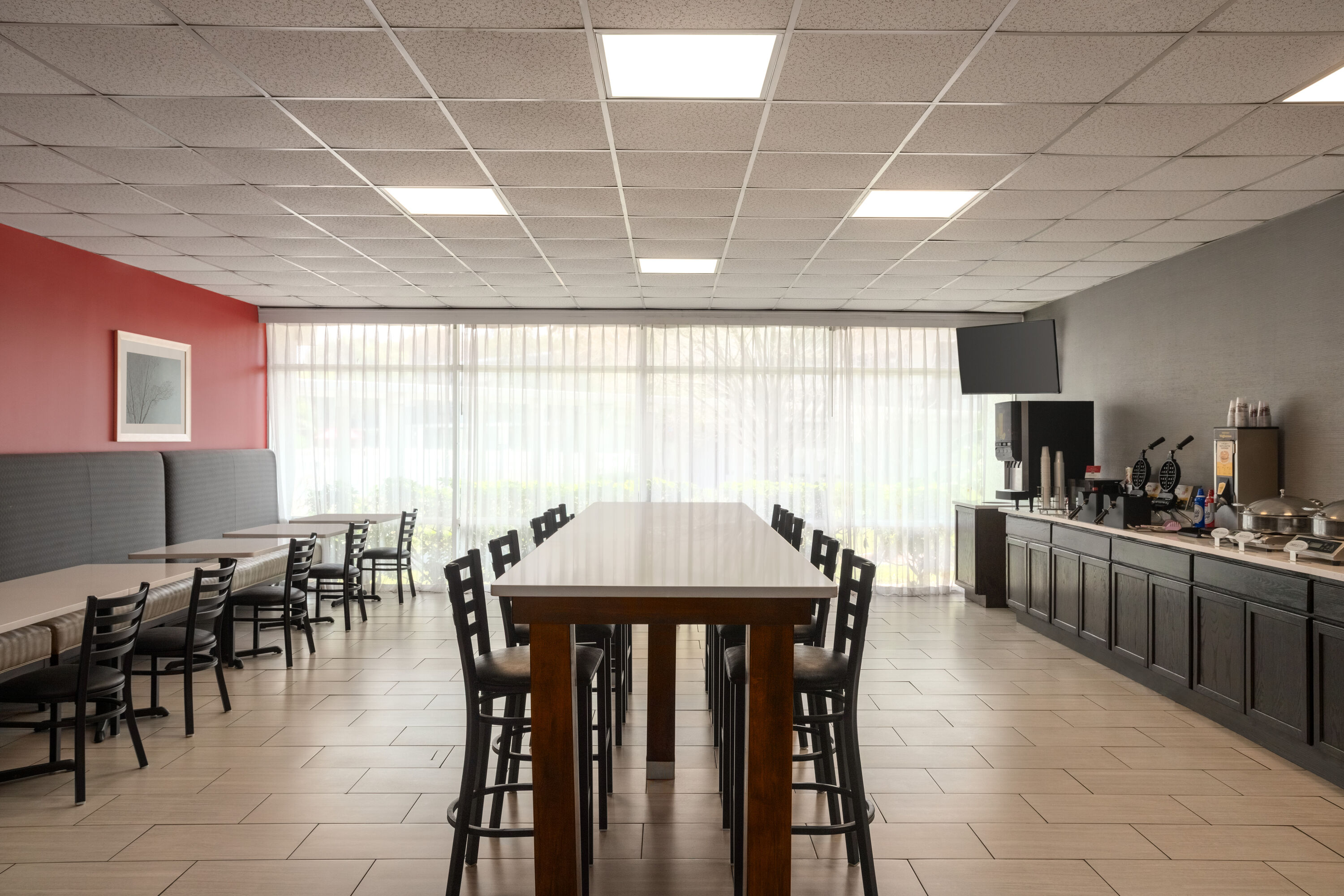 Ramada by Wyndham Cocoa restaurant breakfast area with seating in Cocoa, Florida