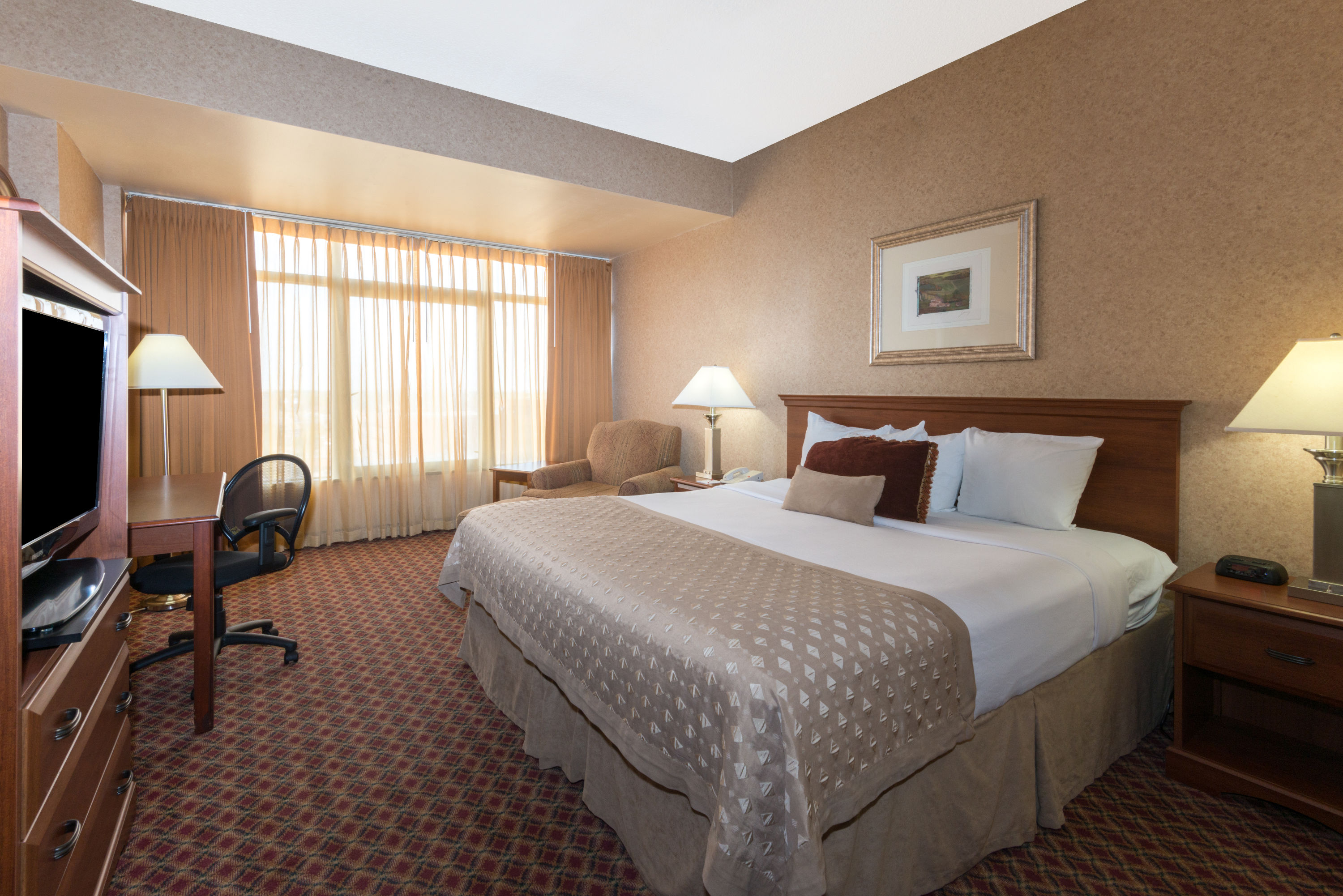 Guest room at the Ramada by Wyndham Topeka Downtown Hotel & Convention Center in Topeka, Kansas