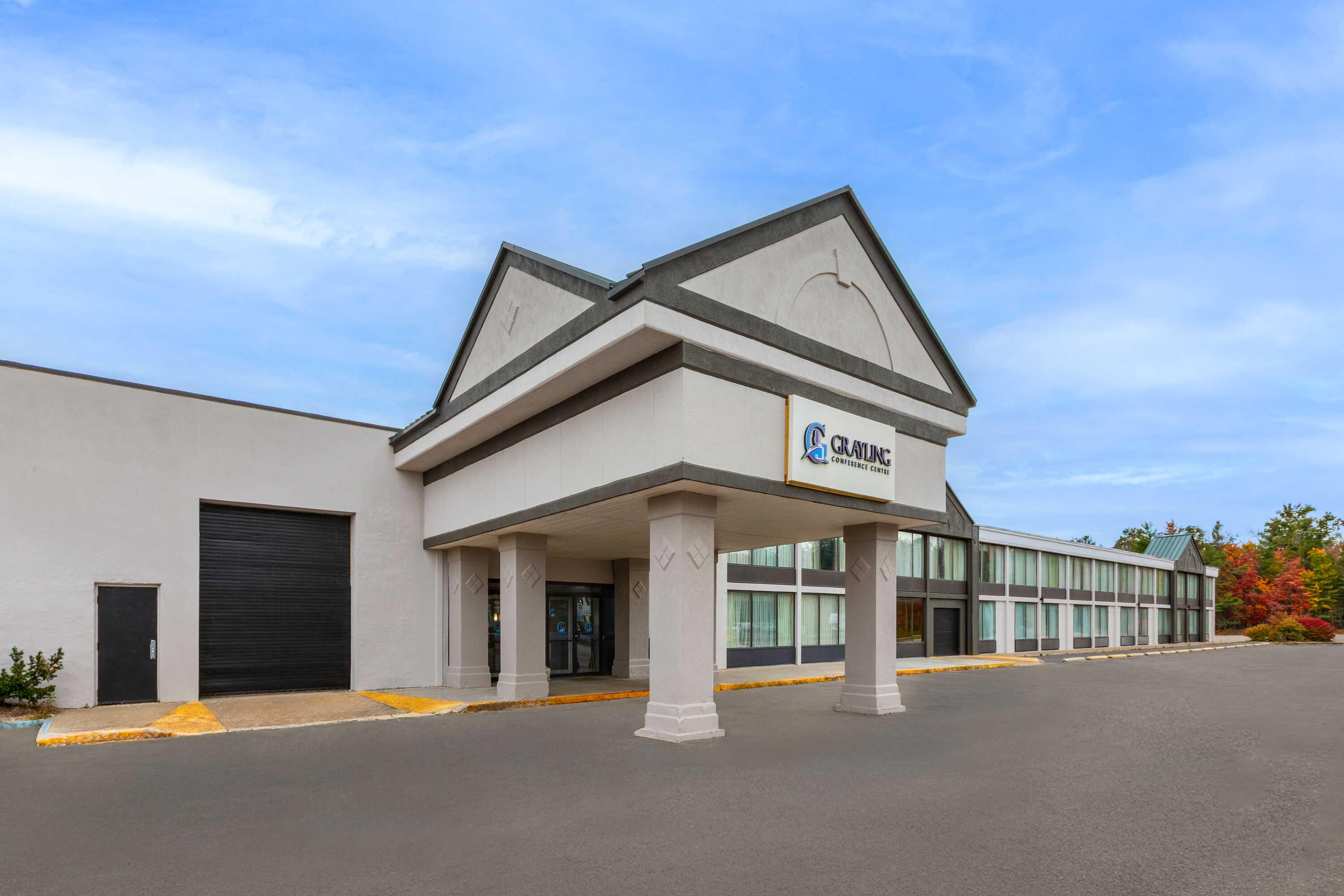 Exterior Day Image of Ramada by Wyndham Grayling Hotel & Conference Center hotel in Grayling, Michigan