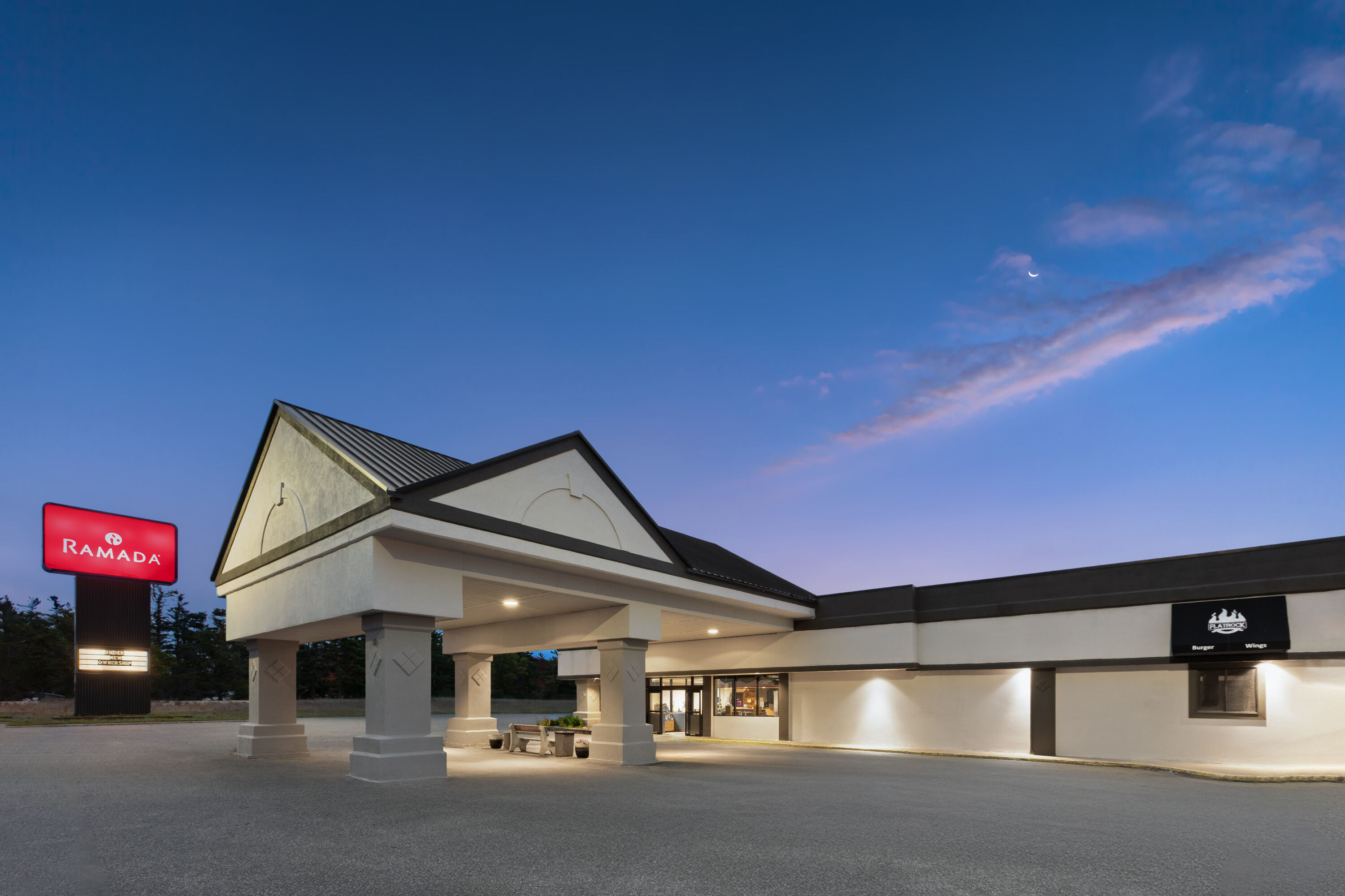 Exterior Dusk Image of Ramada by Wyndham Grayling Hotel & Conference Center hotel in Grayling, Michigan