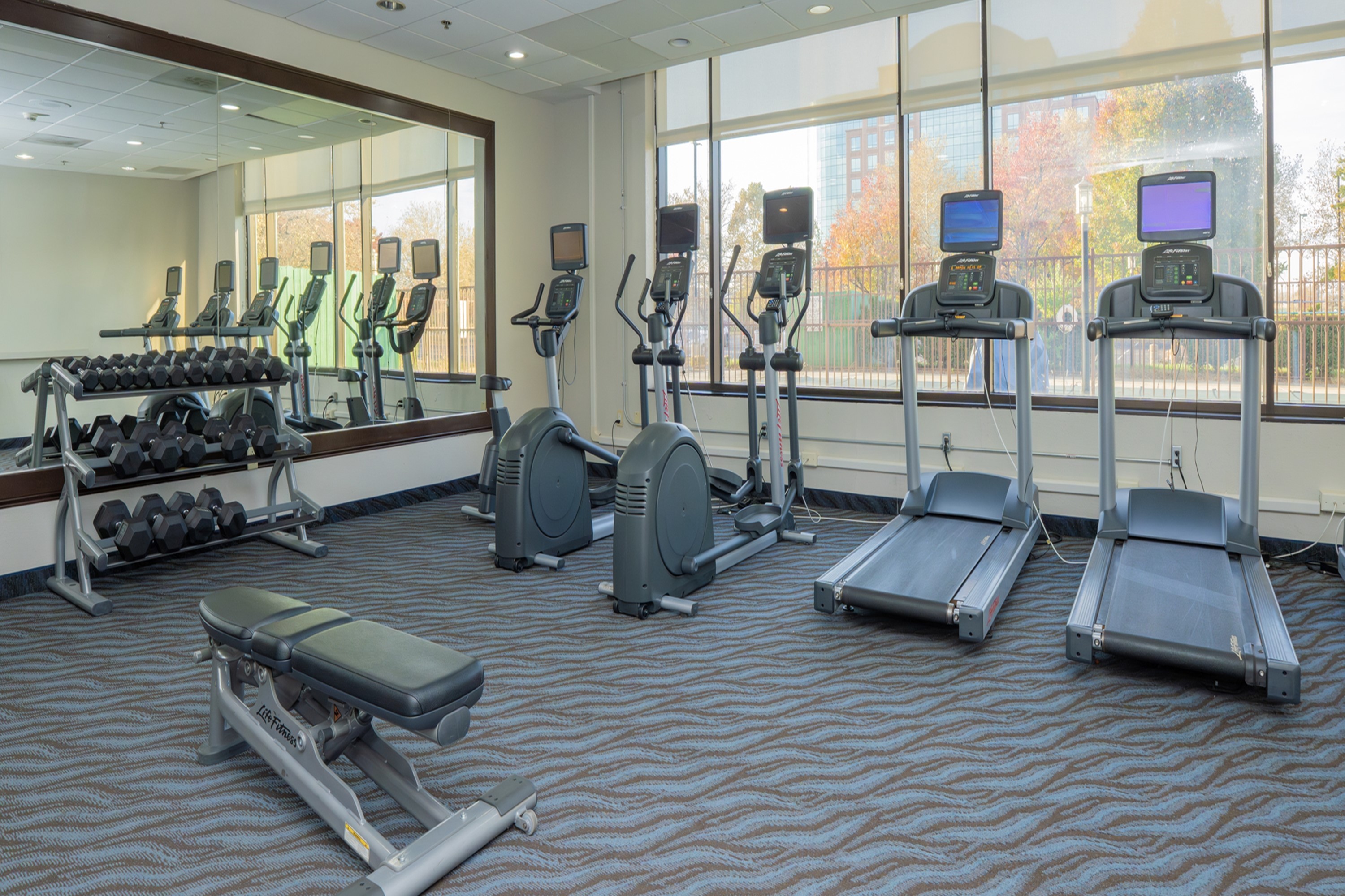 Fitness room at Elimwood Hotel, a Ramada by Wyndham in Maryland Heights, Missouri