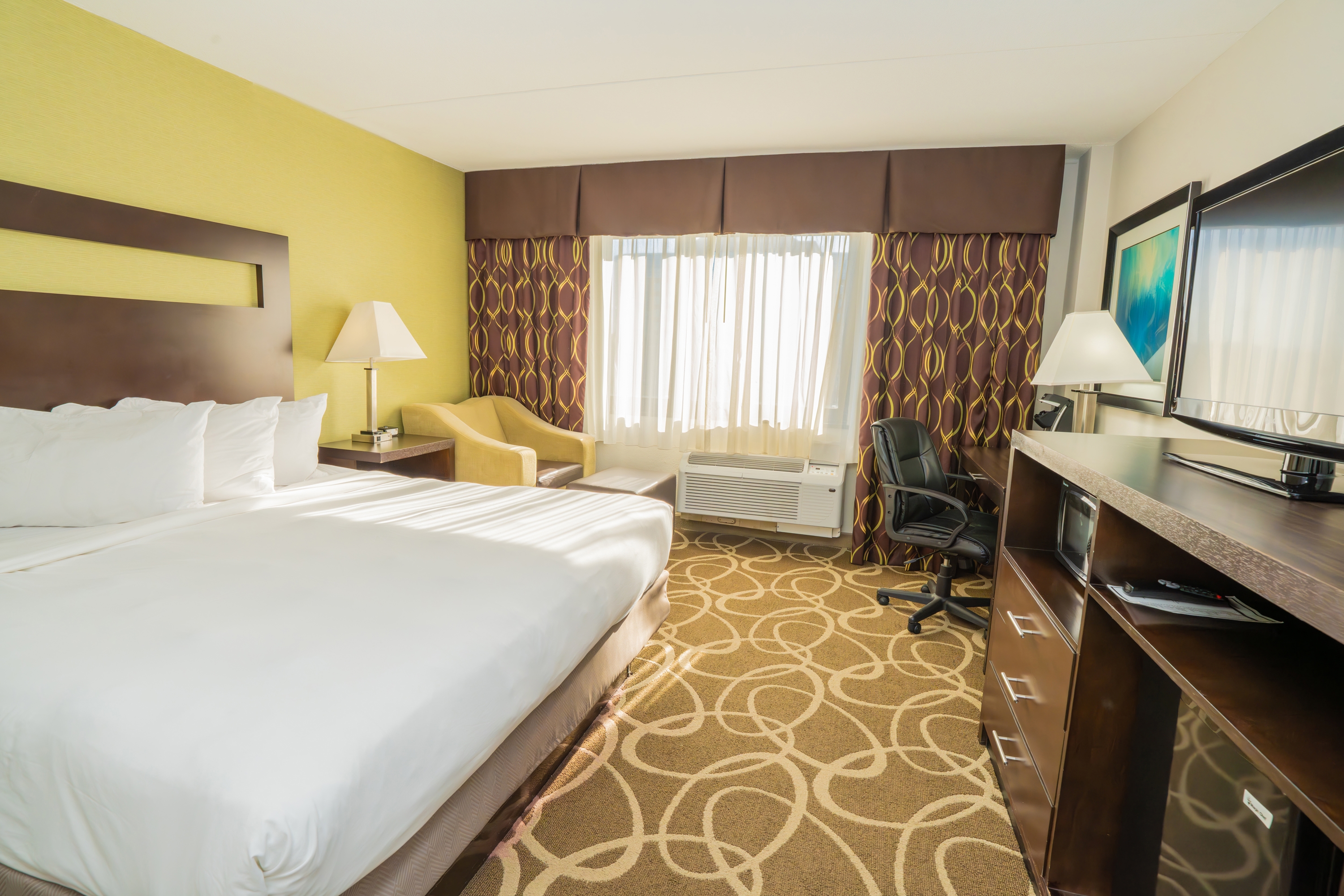 Guest room at the Elimwood Hotel, a Ramada by Wyndham in Maryland Heights, Missouri