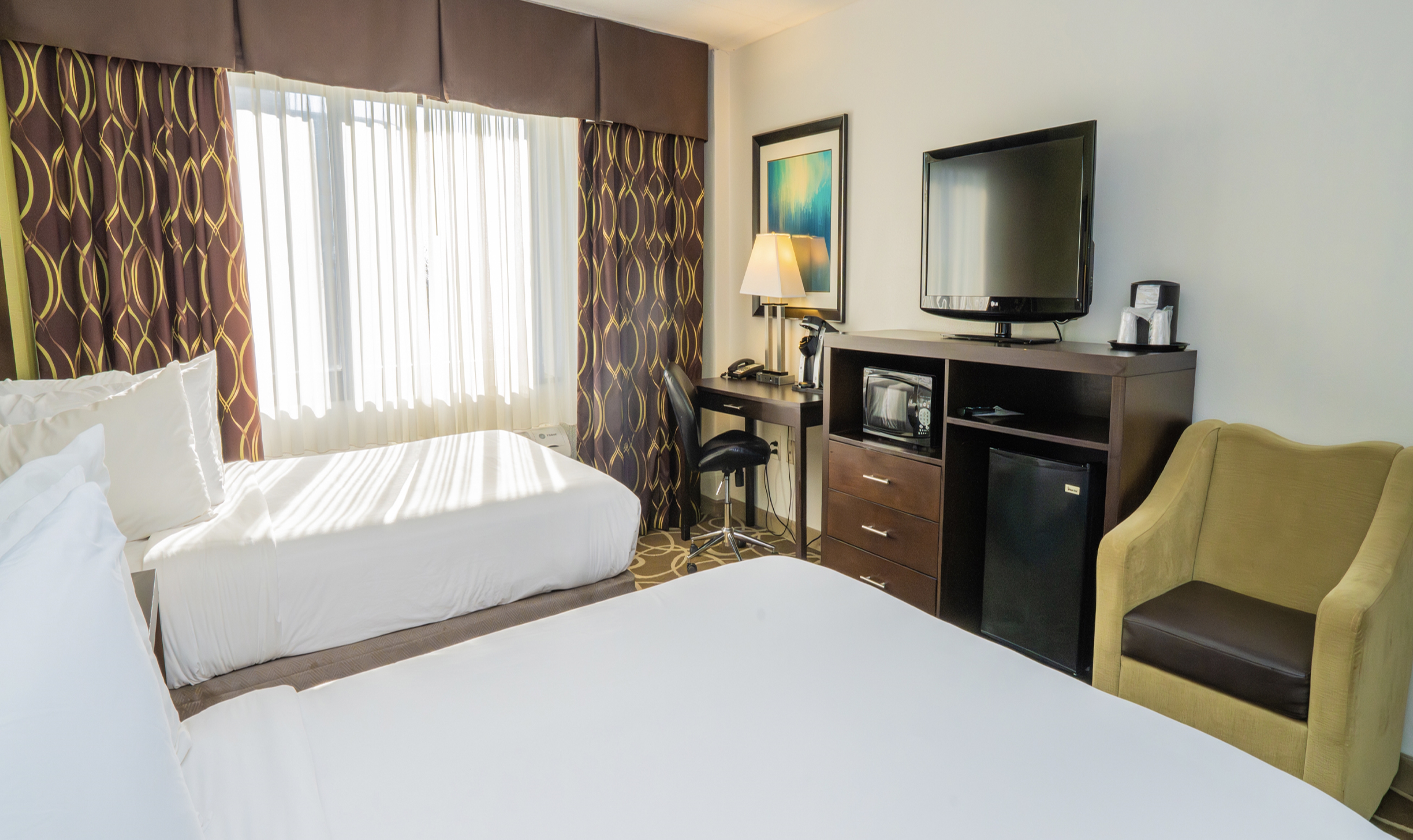 Guest room at the Elimwood Hotel, a Ramada by Wyndham in Maryland Heights, Missouri